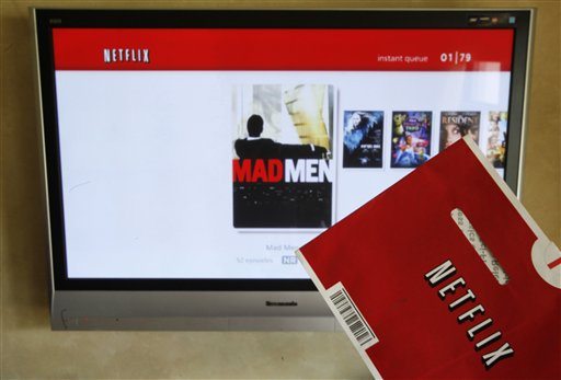 In this Oct. 1, 2011 photo, a Netflix DVD envelope and Netflix on-screen television menu are shown in Surfside, Fla.