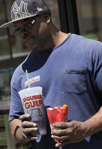A man leaves a 7-Eleven store with a Double Gulp drink in New York, Thursday.