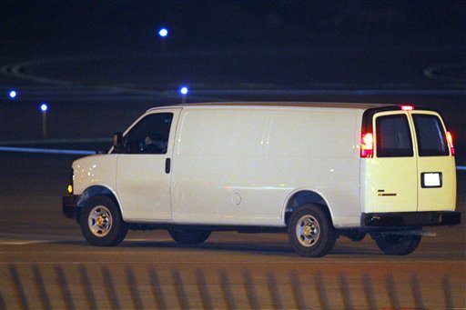 A white van, believed to be transporting Staff Sgt. Robert Bales, leaves Kansas City International Airport Friday, March 16, 2012, in Kansas City, Mo.