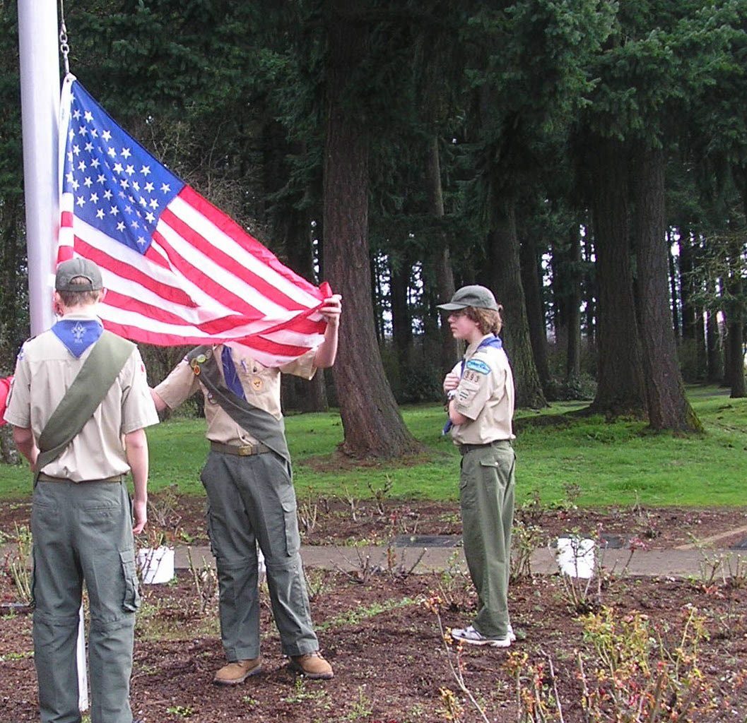 Maple Tree: David Zak, from left, Shawn Sadler and Sean Flynn raise the flag at the rose garden.