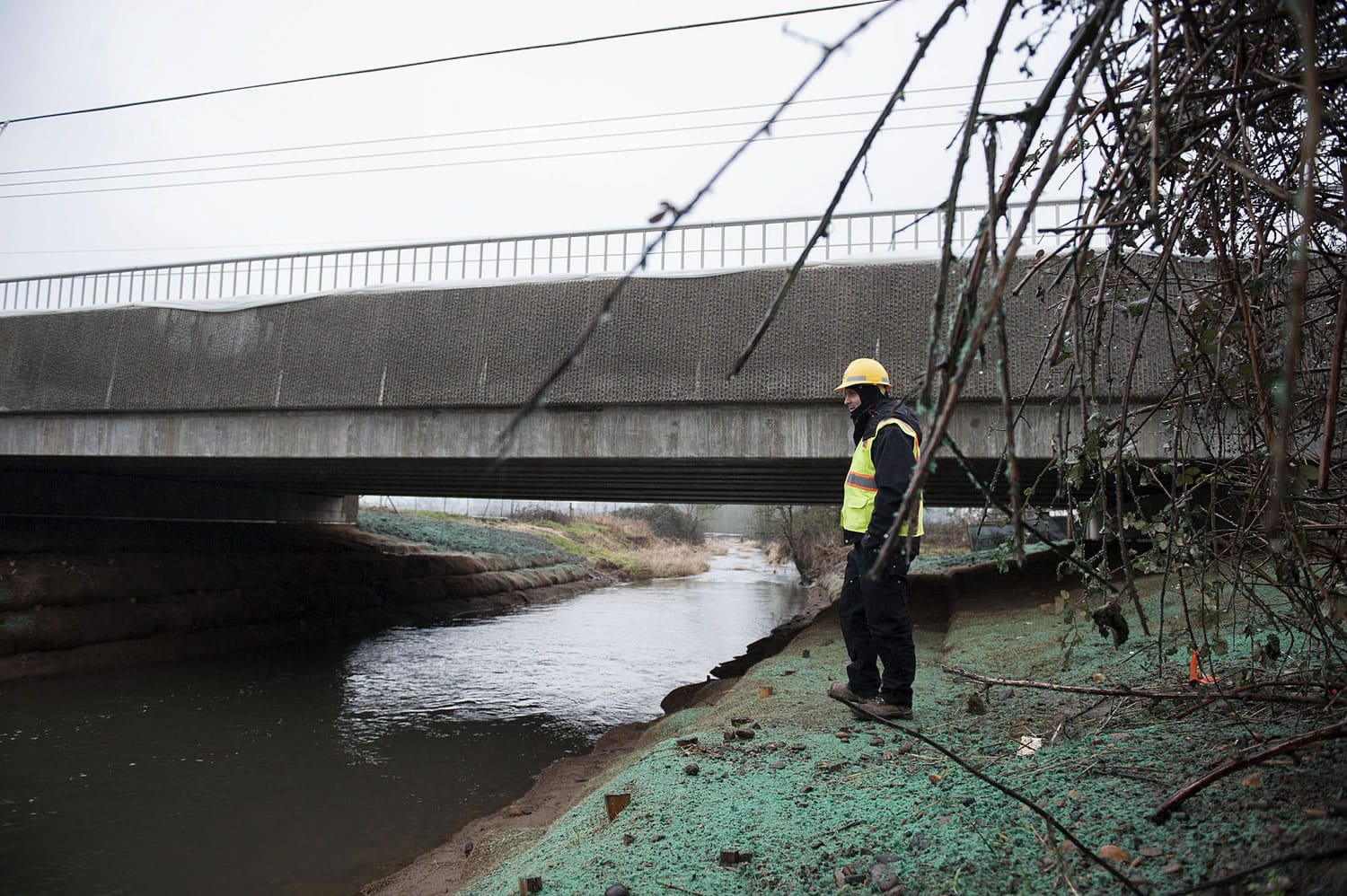 Justin Johnson, inspector for the Clark County Public Works Department, looks over the finished Fifth Plain Creek Bridge on Tuesday.