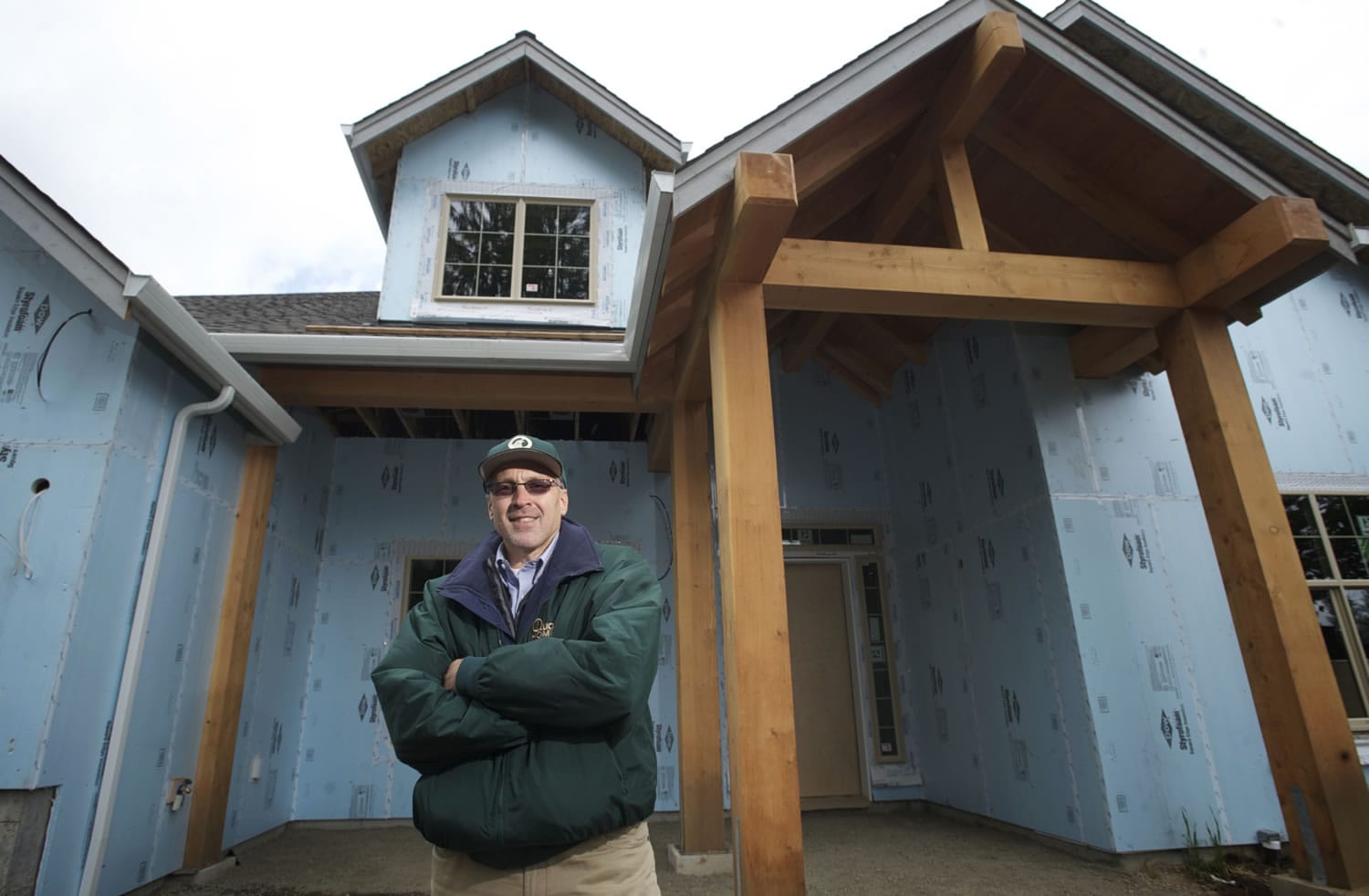 Jon Girod of Quail Homes stands in front of a home under construction in Battle Ground.