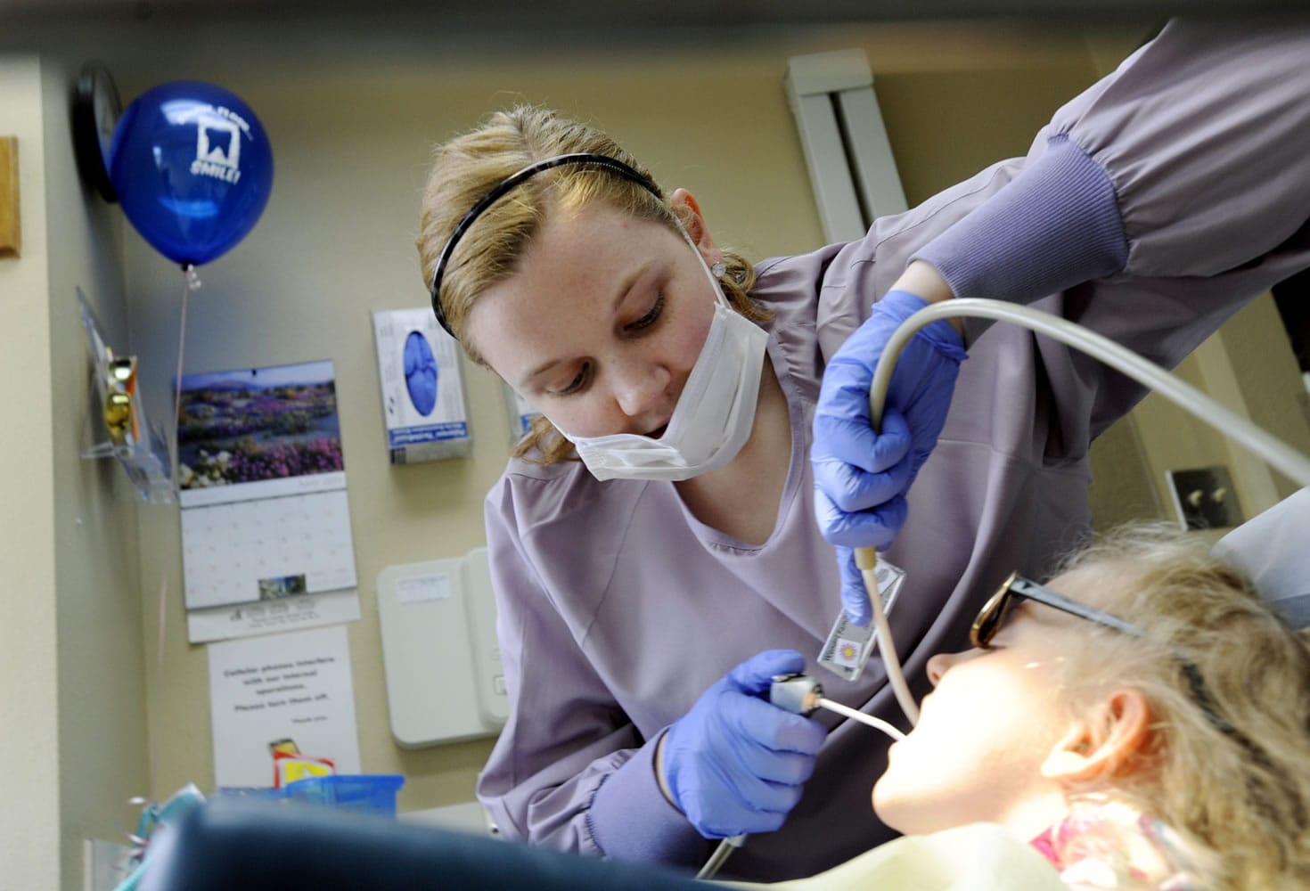 Dental assistant Jenna Bieber cleans Abbey Henkel's teeth at Wendel Dental in Vancouver.