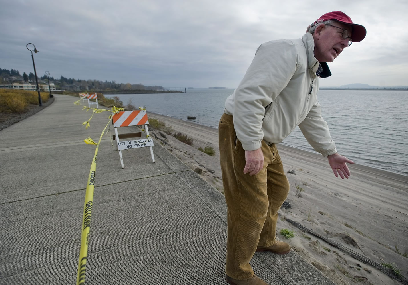 Paul Schwabe, a resident at the Tidewater Cove Condominiums, points out where the banks of the Columbia River are eroding, causing the indefinite closure of the Renaissance Trail.