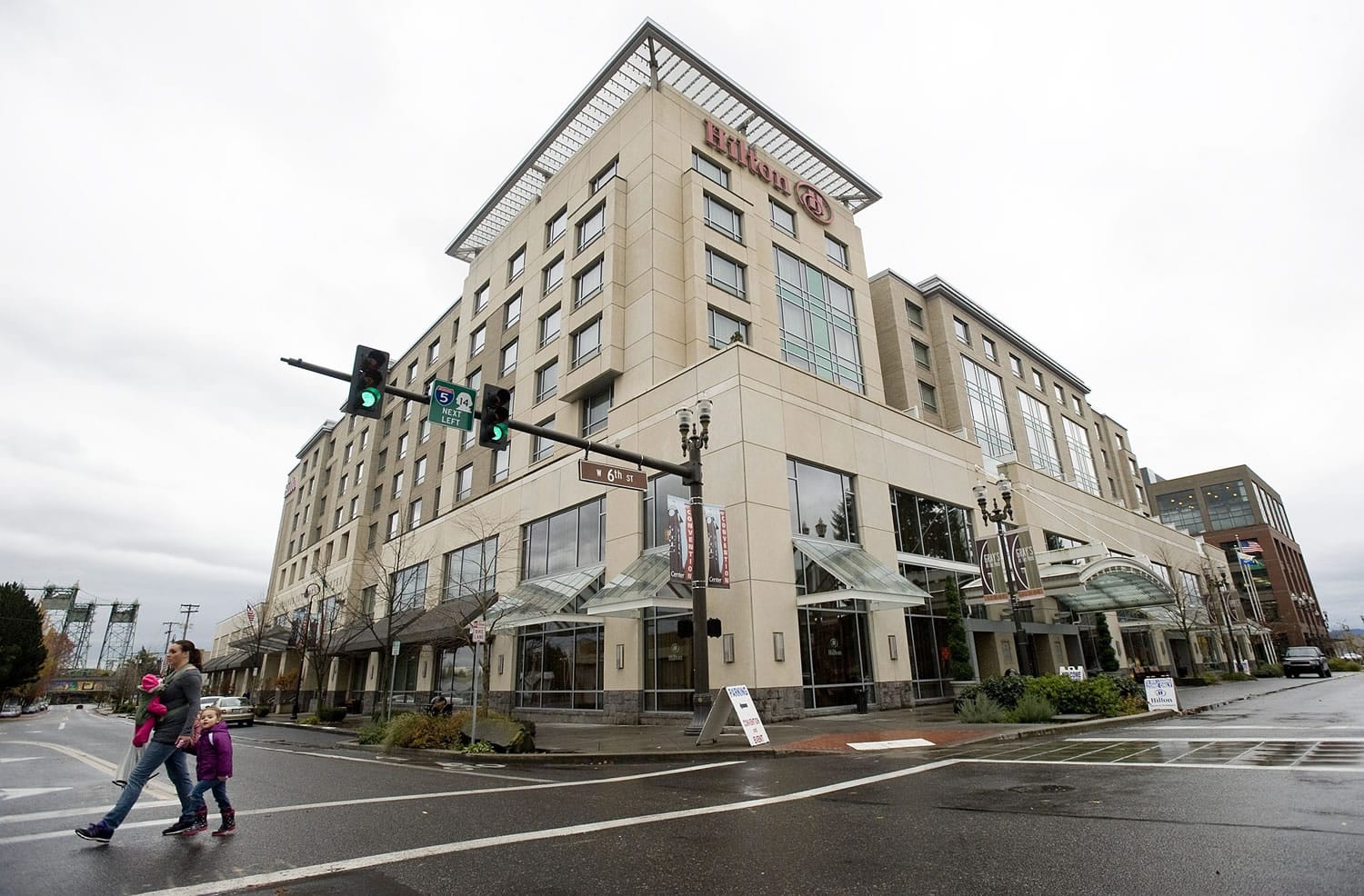 People cross West Sixth Street in front of the Hilton Vancouver Washington this week. City officials estimate that about $350,000 of lodging tax reserves will be needed to make a $2.4 million debt payment due on Jan. 1.