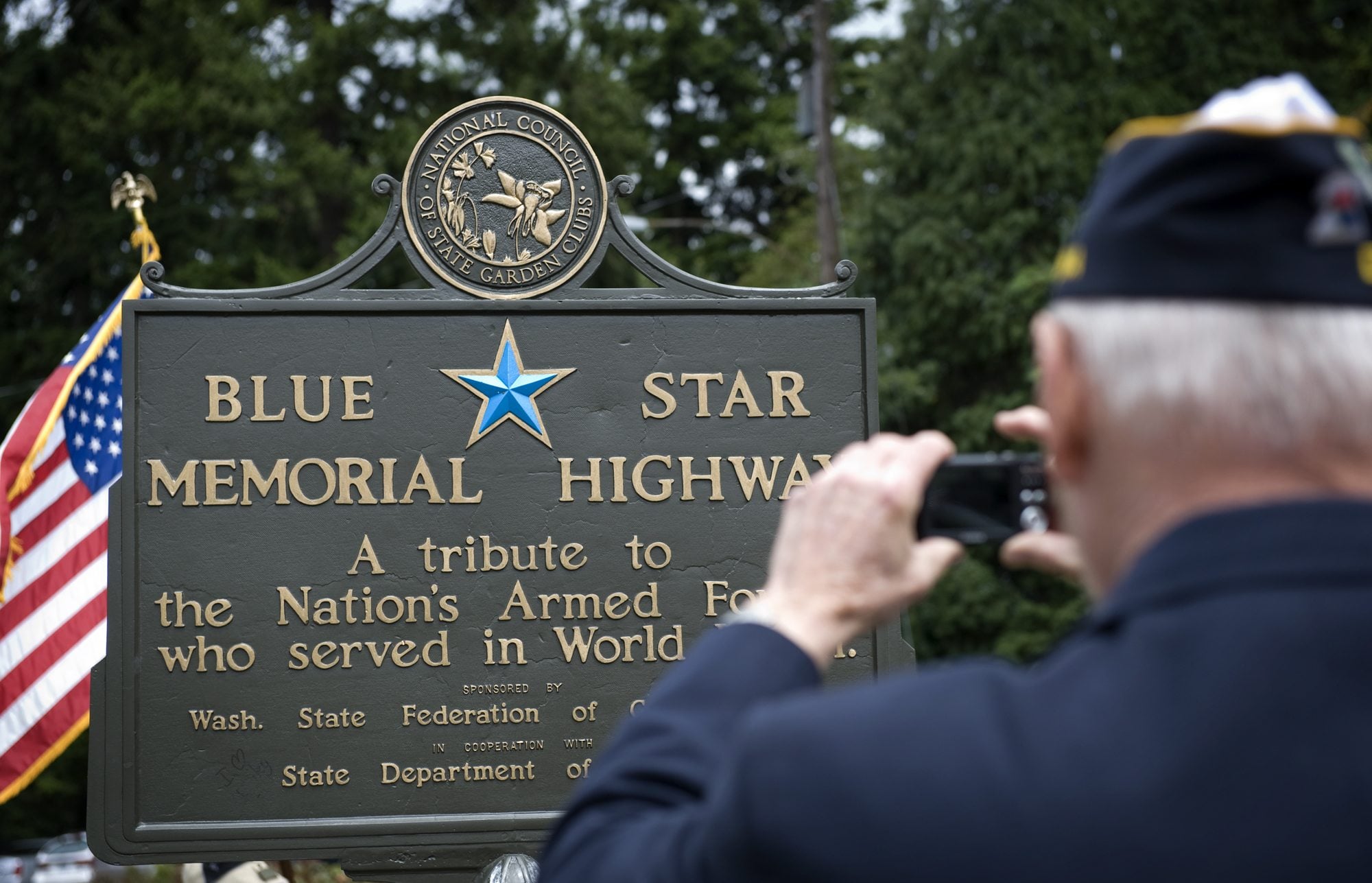 Rev. Jerry L. Keesee takes a photograph of the Blue Star Memorial Highway marker that was refurbished after vandals damaged it, during a re-dedication ceremony on Monday June 21, 2010.