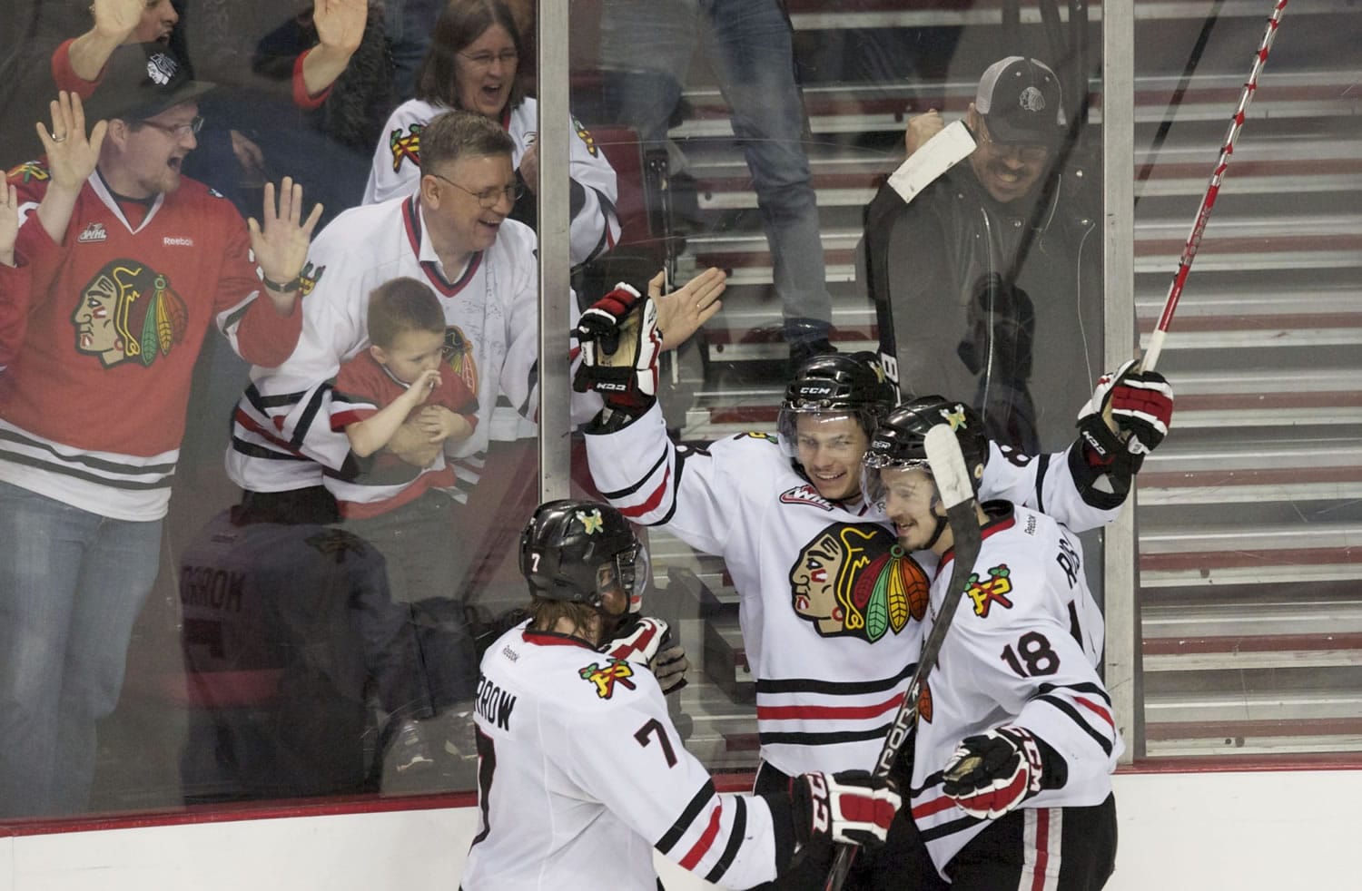 Portland Winterhawks' Ty Rattie, center, celebrates with Joseph Morrow, 7, and Brad Ross, 18, after he scored the game-winner against the Tri-City Americans during the Westernn Conference Playoffs at the Rose Garden.