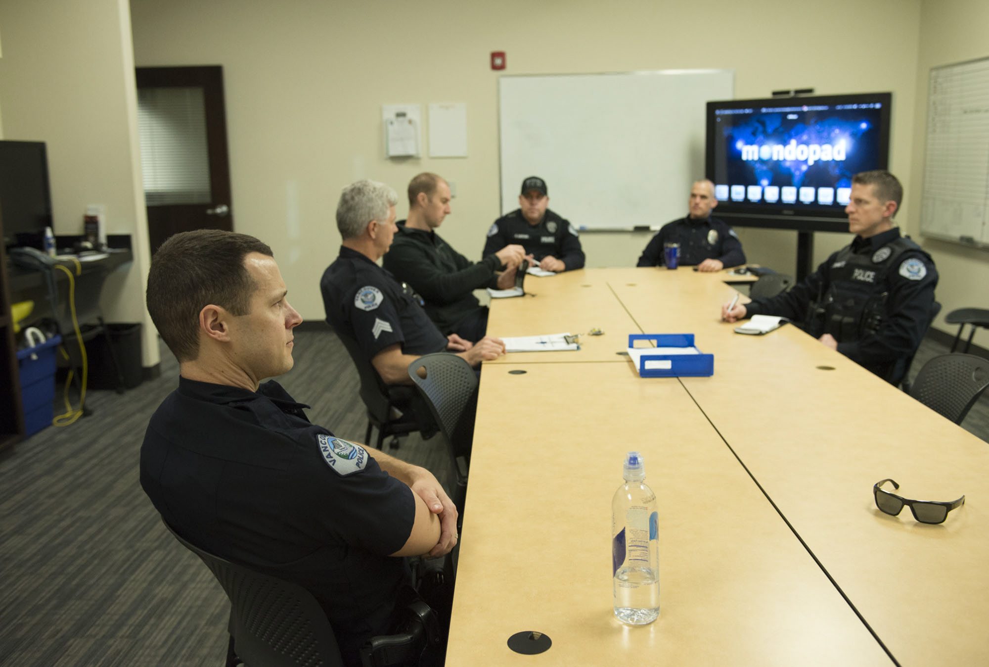 Officer David Krebs, left, listens during a squad briefing Friday afternoon at Vancouver Police Department&#039;s West Precinct. The police chief has proposed adding 42 more officers to the department, which now has 190 officers.