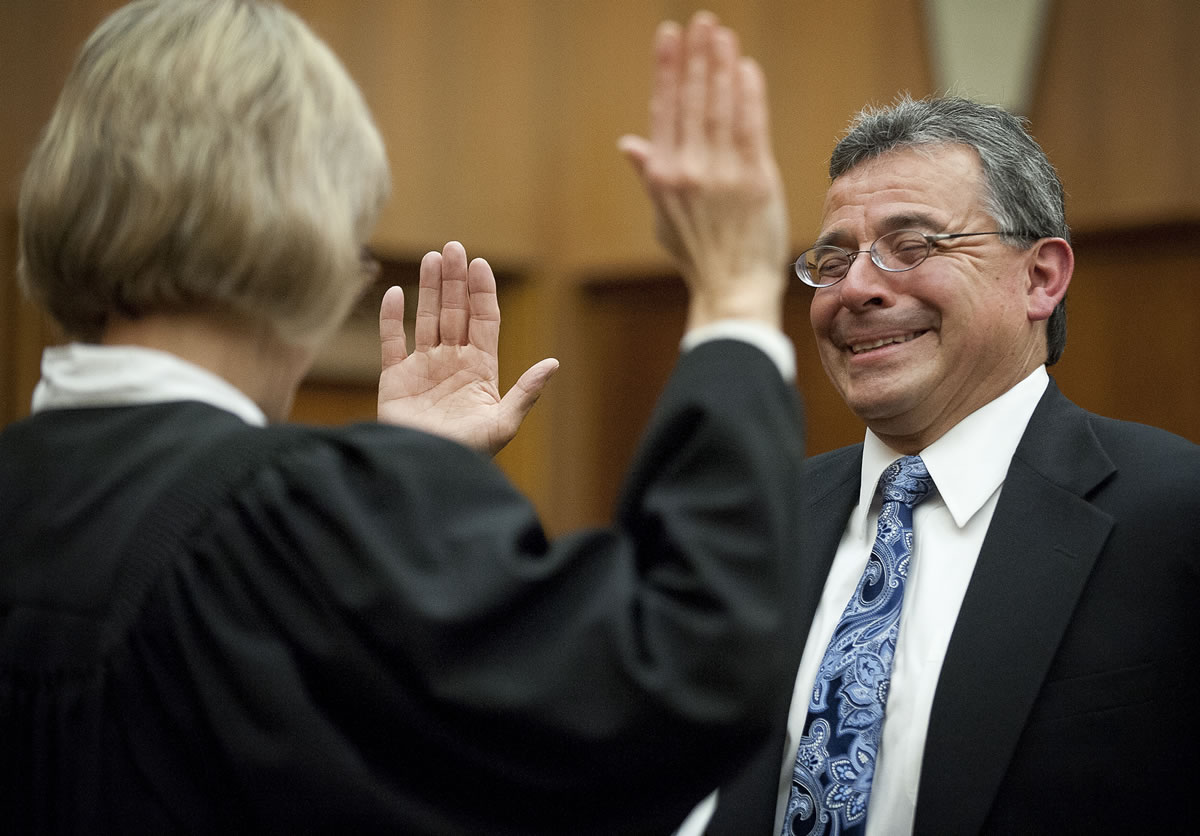 Gregory Gonzales, the newly appointed Superior Court judge, is sworn in Friday afternoon by Clark County Superior Court Presiding Judge Barbara Johnson in her courtroom.