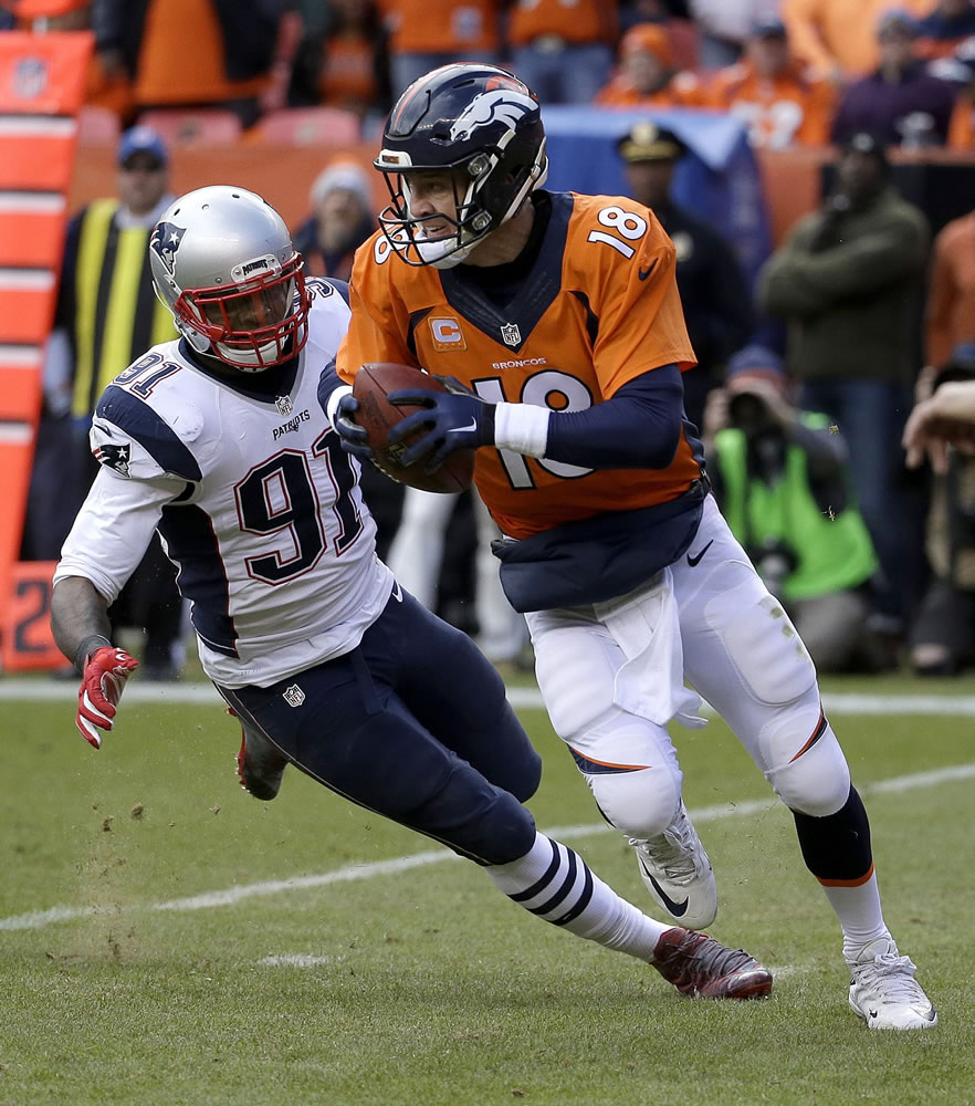 Denver Broncos quarterback Peyton Manning evades a tackle by New England Patriots outside linebacker Jamie Collins (91) during the first half of the NFL football AFC Championship game between the Denver Broncos and the New England Patriots, Sunday, Jan. 24, 2016, in Denver.