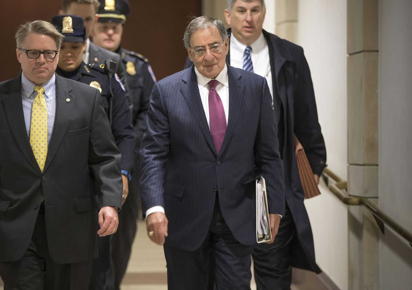 Former Defense Secretary Leon Panetta, center, is escorted to a secure floor on Capitol Hill in Washington, Friday, Jan. 8, 2016, to be questioned in a closed-door hearing of the House Benghazi Committee. The panel, chaired by Rep. Trey Gowdy, R-S.C., is investigating the 2012 attacks on the U.S. consulate in Benghazi, Libya, where a violent mob killed four Americans, including Ambassador Christopher Stevens.  (AP Photo/J.