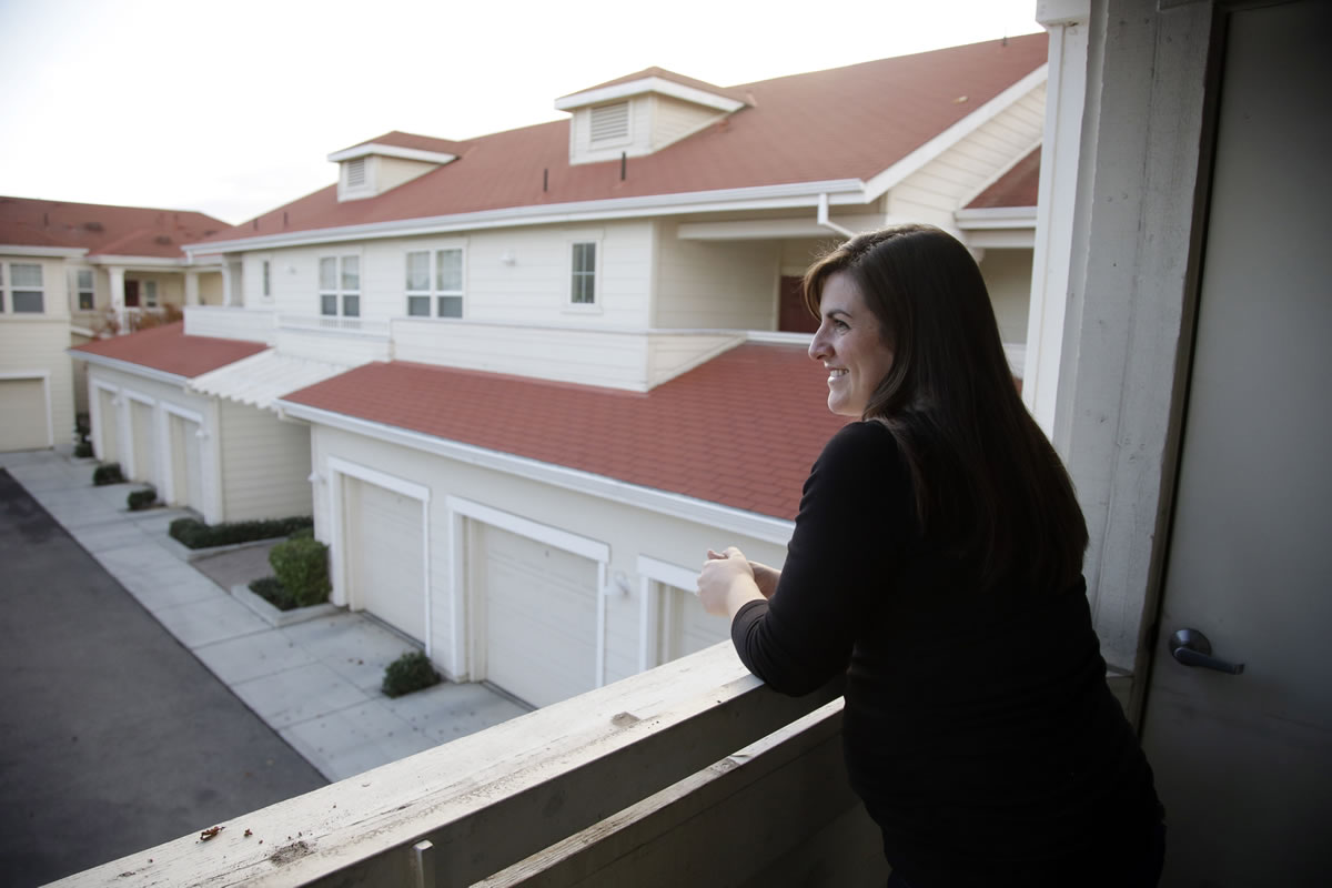 Kindergarten teacher Katy Howser looks out from her balcony at an apartment complex for teachers in Santa Clara, Calif.