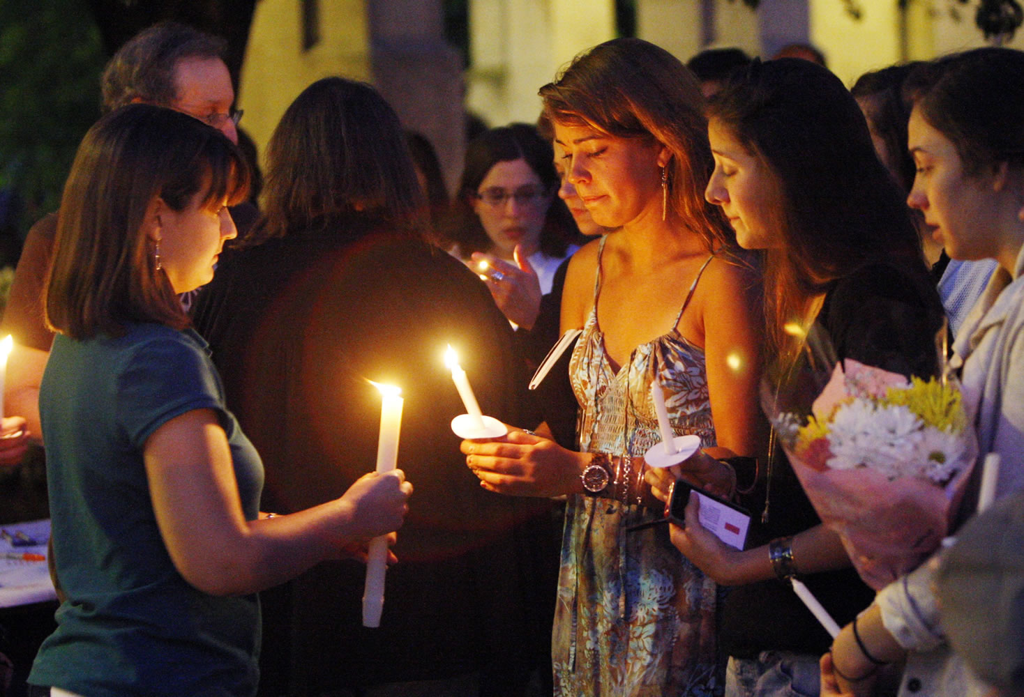 Boston University students including Tori Pinheiro, third right, of New Bedford, Mass., and Austin Brashears' girlfriend, holds a candlelight vigil on Marsh Plaza at Boston University, Saturday, May 12, 2012, in Boston, for three students studying in New Zealand who were killed when their minivan crashed during a weekend trip. Daniela Lekhno, 20, of Manalapan, N.J.; Austin Brashears, 21, of Huntington Beach, Calif.; and Roch Jauberty, 21, whose parents live in Paris, were killed as they traveled in a minivan Saturday near the North Island vacation town of Taupo when the vehicle drifted to the side of the road and then rolled when the driver tried to correct course.