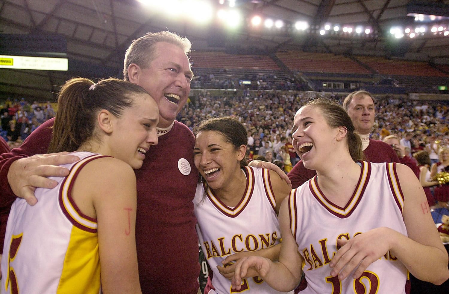 Prairie coach Al Aldridge congratulates Jessica Menkens, left, Ticey Westbrooks and Lauren Short, right, after Prairie beat Central Valley for the 4A State basketball championship at the Tacoma Dome.