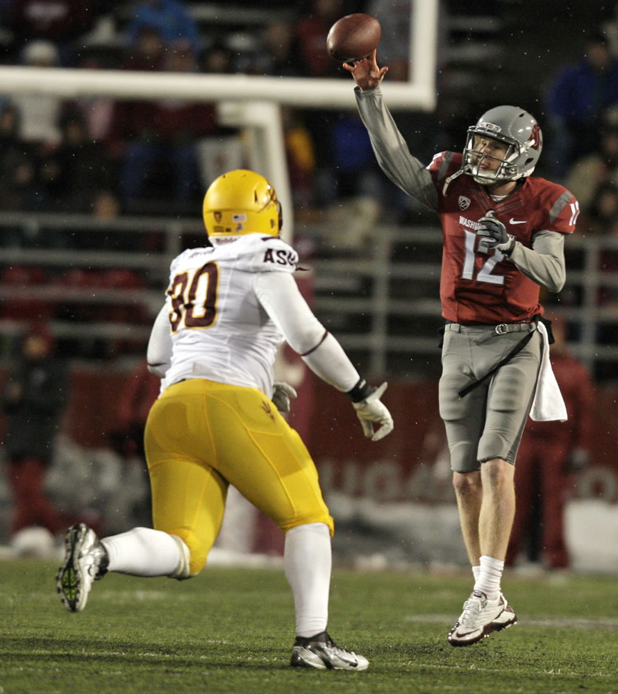 Washington State quarterback Connor Halliday (12) attempts a pass under pressure by Arizona State defensive tackle Will Sutton (90) during the first half Saturday.