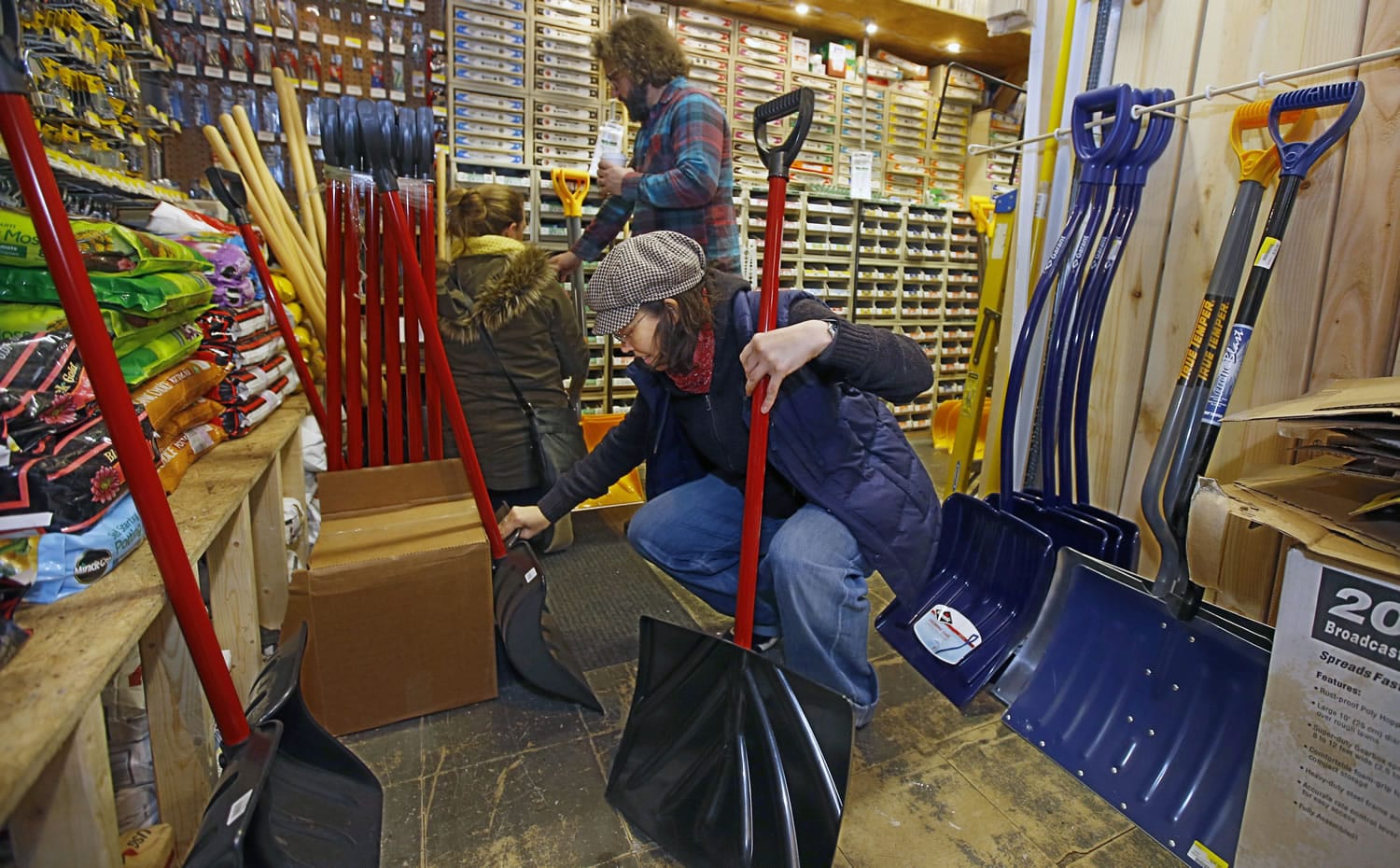 Patty O&#039;Brien, front, checks out the selection of snow shovels Thursday at Rittenhouse Hardware in Philadelphia.