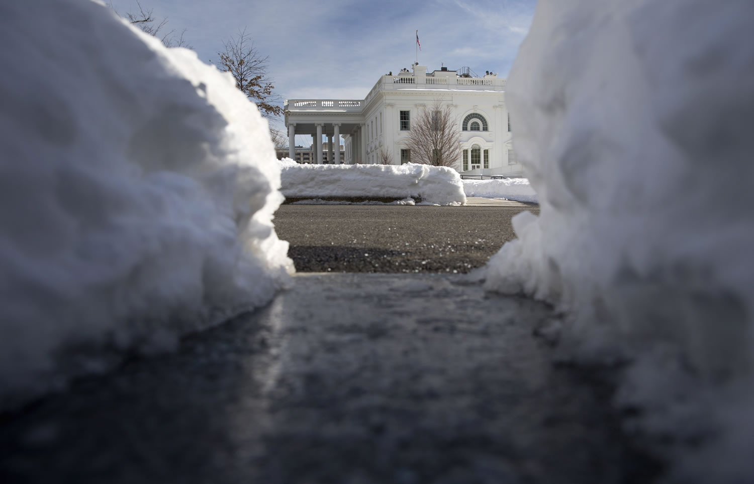 Paths and a driveway are cleared of snow on the White House grounds in Washington on Monday.