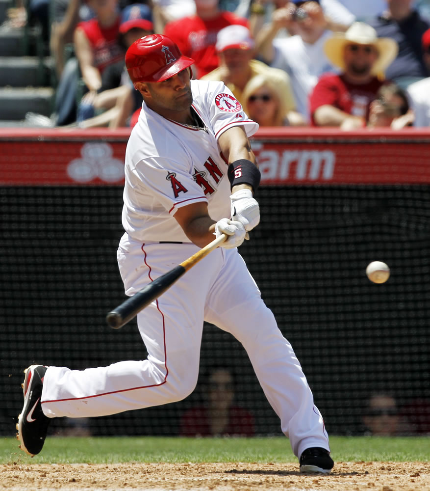 Los Angeles Angels' Albert Pujols hits a two-run home run against the Toronto Blue Jays during the fifth inning of a baseball game in Anaheim, Calif., Sunday, May 6, 2012. This was Pujols' first home run of the season.