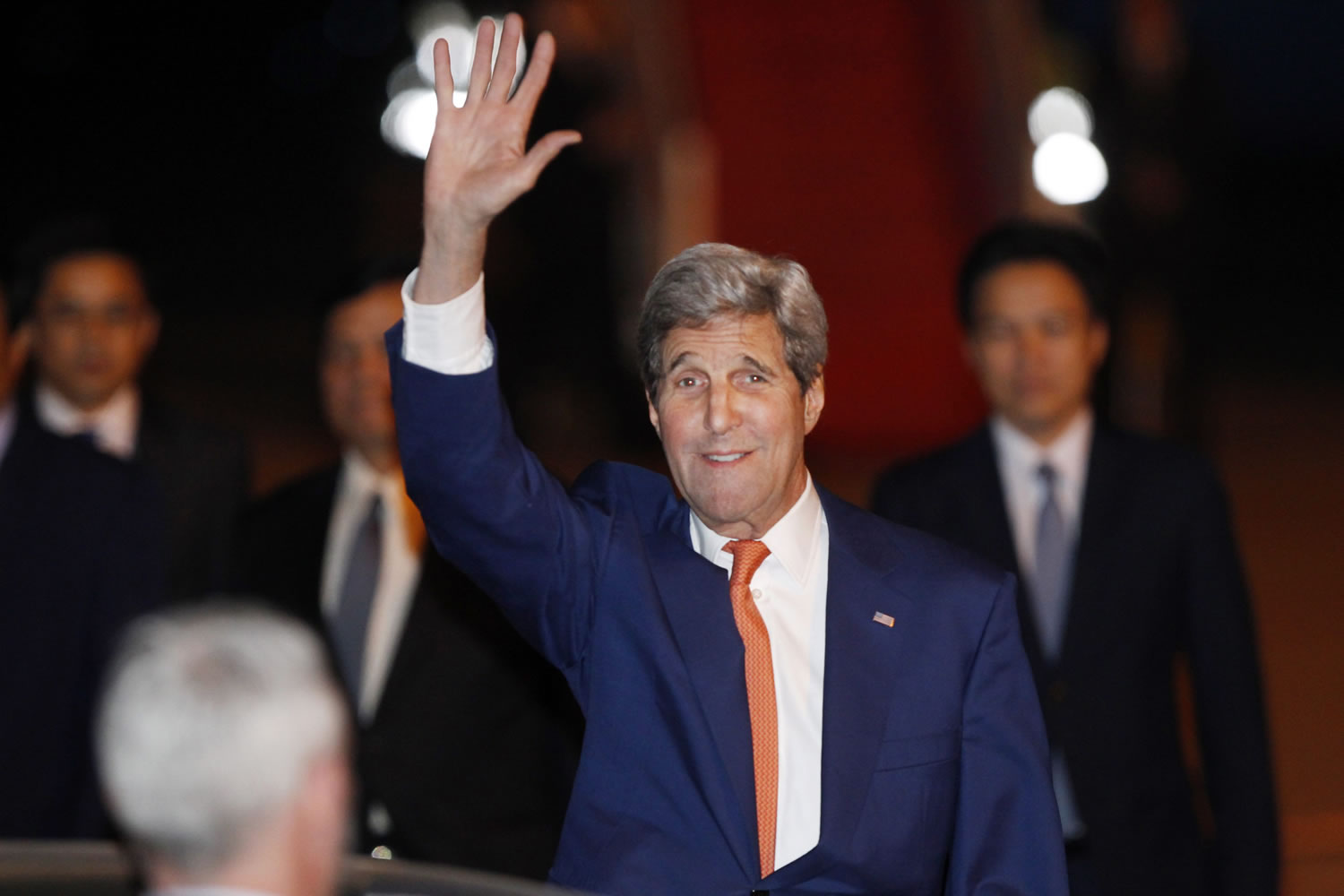 U.S. Secretary of States John Kerry, second from right, waves at Cambodian officials upon his arrival at Phnom Penh International Airport in Phnom Penh, Cambodia, on Monday. Kerry arrived in Phnom Penh for his two-day official visit to Cambodia.