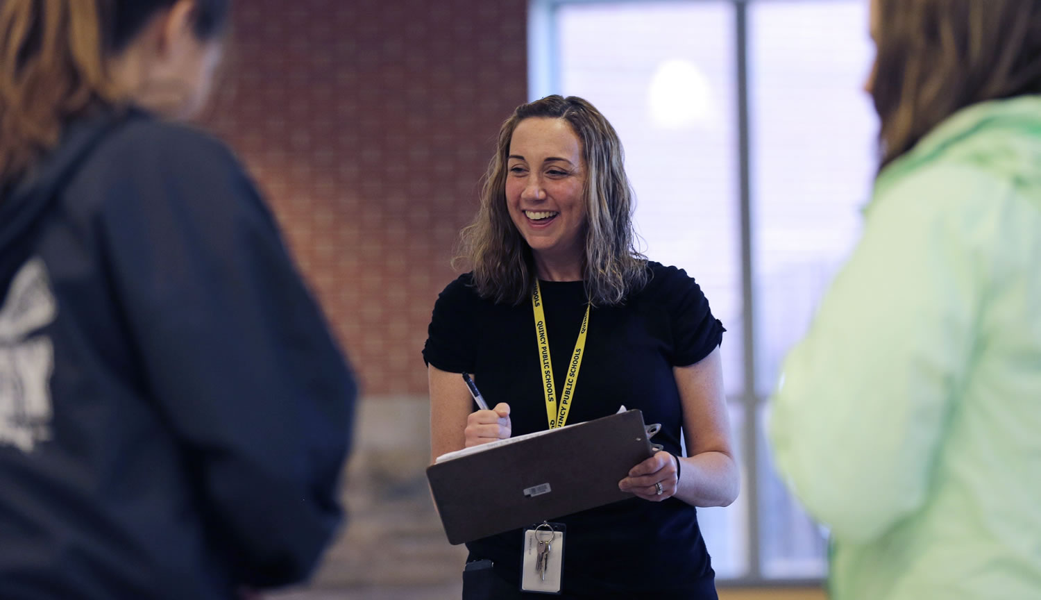 Cancer survivor Christine Ells talks with her students as she takes attendance at Quincy High School in Quincy, Mass. Ells, 36, developed a heart rhythm problem from several drugs she was given to treat the breast cancer she was diagnosed with at age 27.