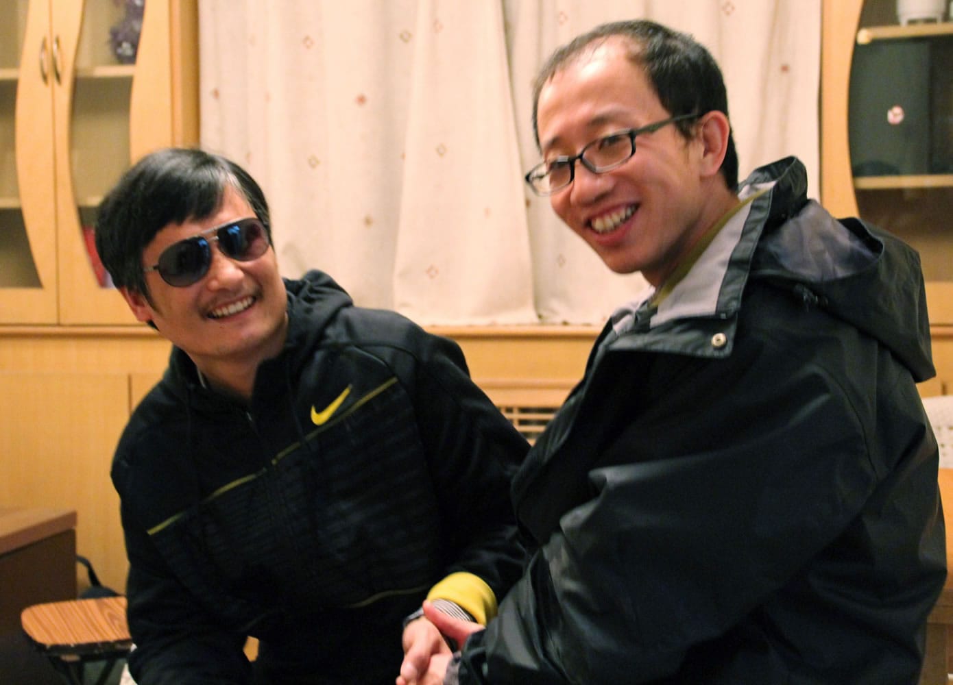 In this photo taken in late April, 2012, and provided by Hu Jia, blind Chinese legal activist Chen Guangcheng, left, meets with Hu at an undisclosed location. Chen, an inspirational figure in China's rights movement, slipped away from his well-guarded rural village on Sunday night, April 22, 2012, and made it to a secret location in Beijing on Friday, April 27, setting off a frantic police search for him and those who helped him, activists said.