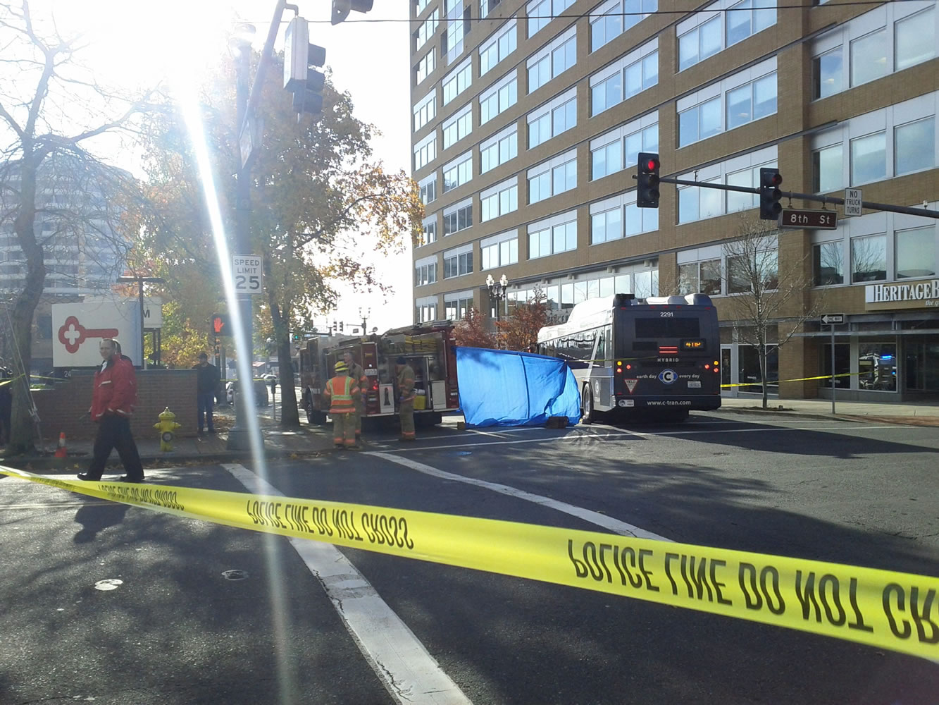 Rescuers are working to extract the victim from under a C-Tran bus at 8th and Washington Streets in Vancouver.