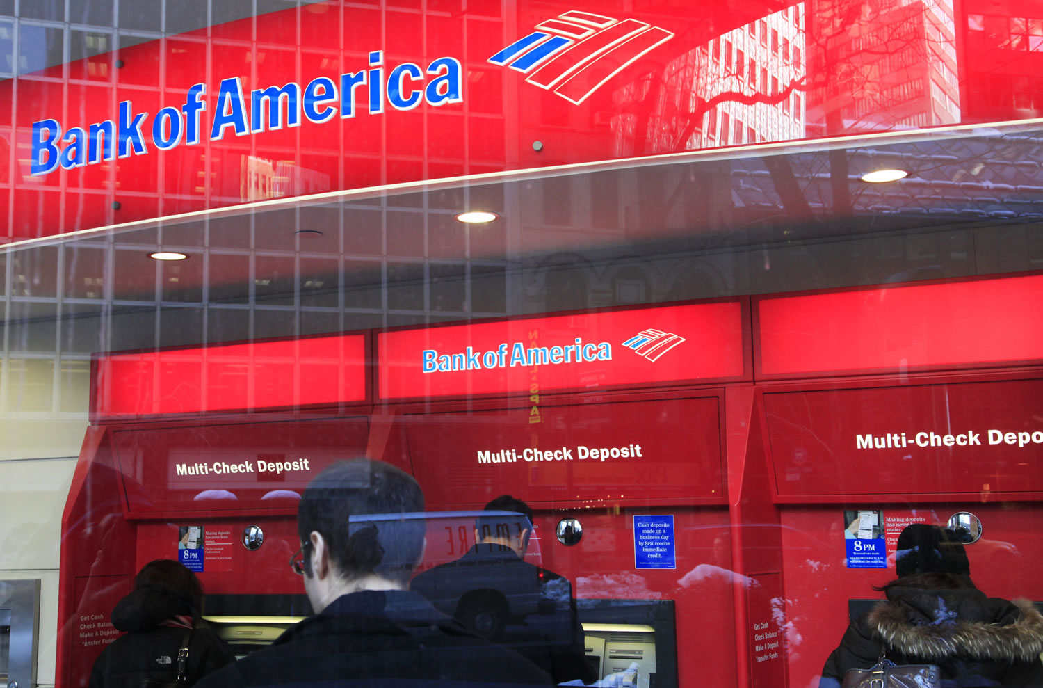Bank of America customers use ATM machines Jan. 31 in New York.