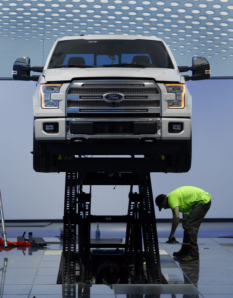 A worker builds a Ford display Thursday in preparation for this week&#039;s North American International Auto Show in Detroit. Ford, Fiat Chrysler, Aston Martin, Chevrolet will take part in the show, which opens to the public Saturday.