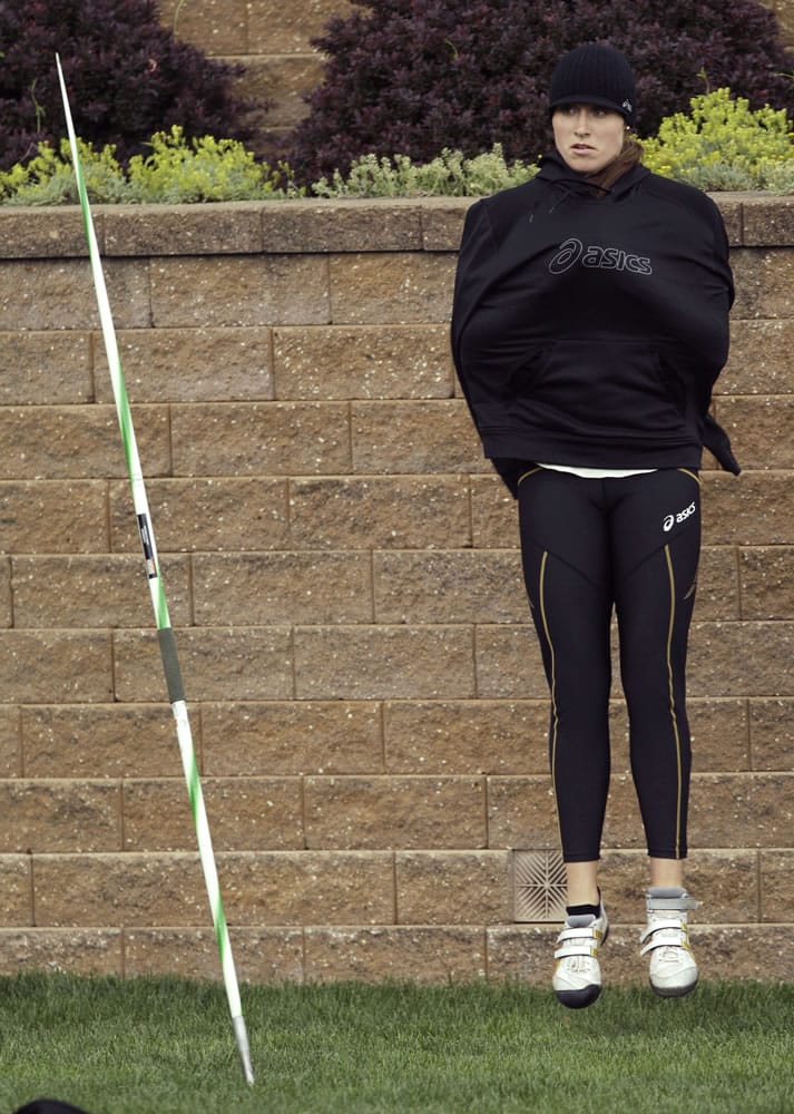 Kara Patterson tries to stay warm before throwing during the women's javelin at the Drake Relays athletics meet on Friday, April 27, 2012, in Des Moines, Iowa.