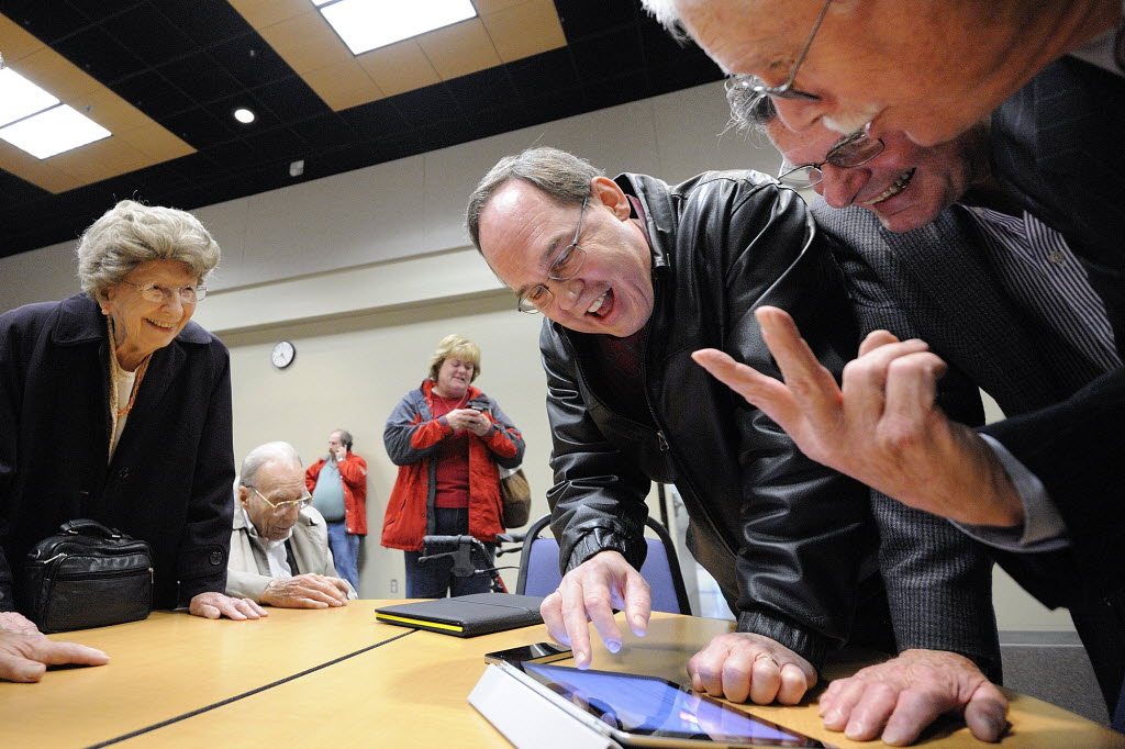 Val Ogden, left, watches as Jack Burkman, Ron Onslow, mayor of Ridgefield, and Brian Wolfe, port commissioner, look over election results at Gaiser Hall at Clark College Tuesday November 8, 2011 in Vancouver, Washington.