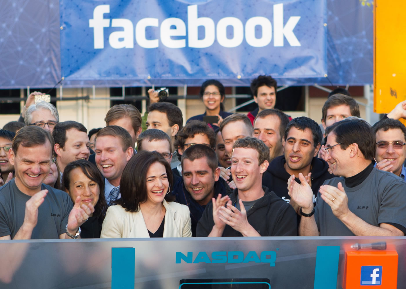 Facebook founder, Chairman and CEO Mark Zuckerberg, center, applauds at the opening bell of the Nasdaq stock market Friday from Facebook headquarters in Menlo Park, Calif., as the social networking giant launched its IPO.