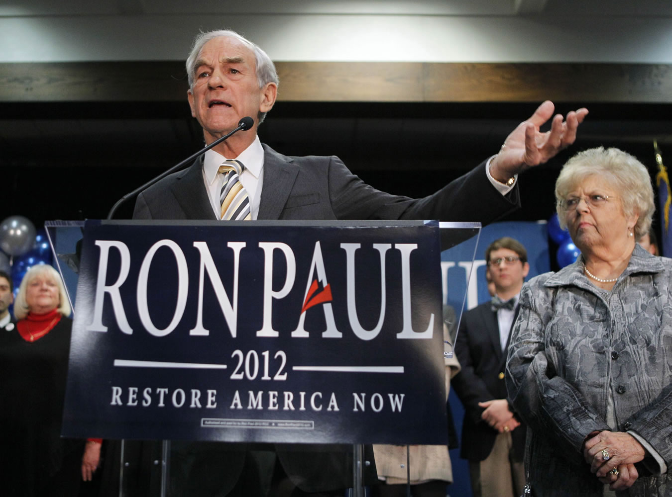 Republican presidential candidate Rep. Ron Paul, R-Texas, left, with his wife Carol Paul, speaks to supporters Saturday in Portland, Maine.