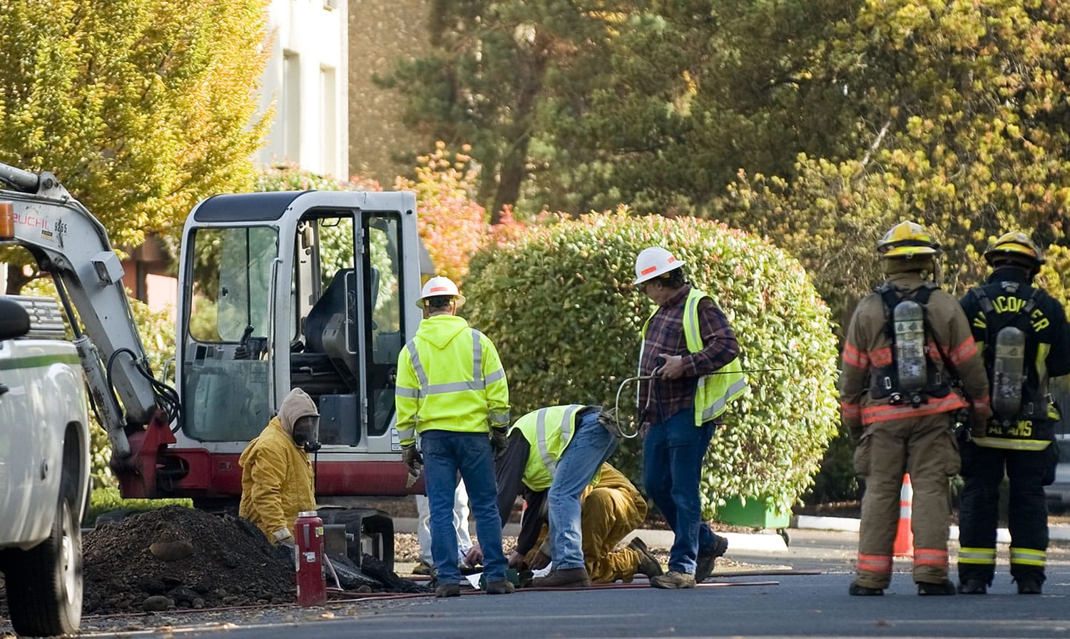 Crews work to fix a gas line leak on East 12th Street between C and D Streets on Thursday.