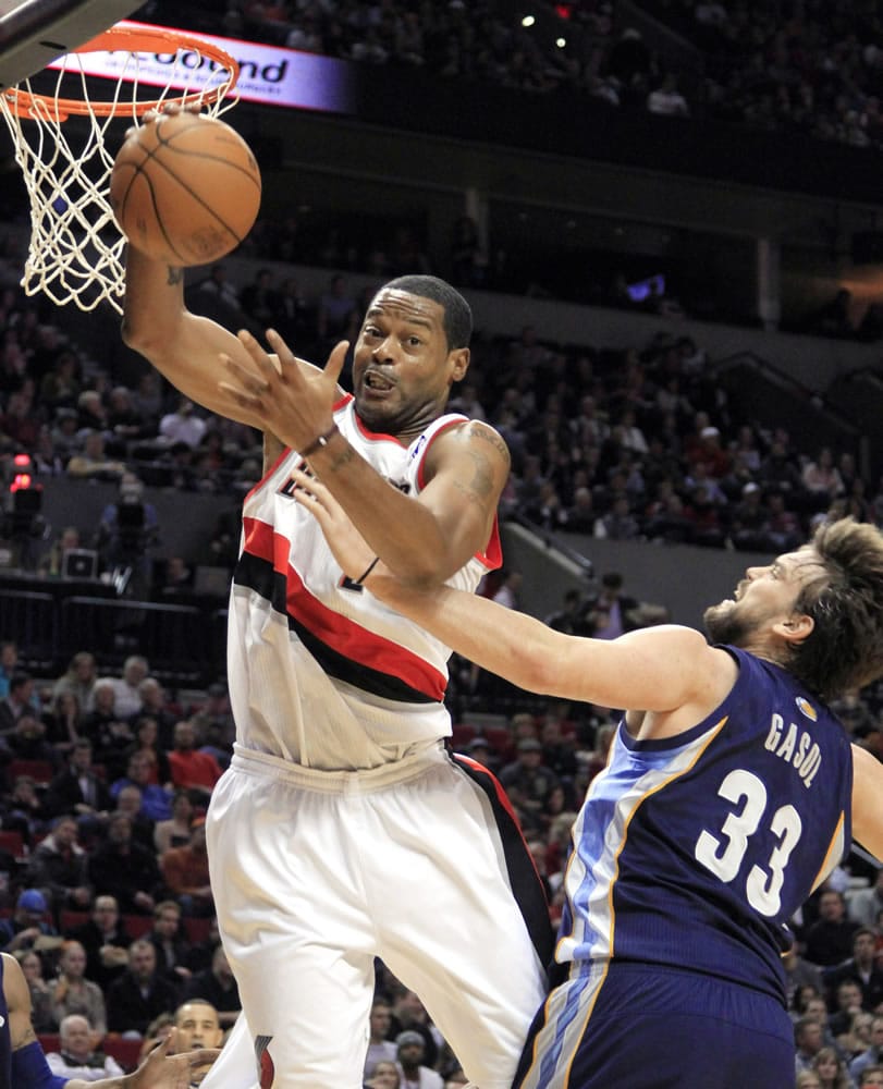 Portland Trail Blazers center Marcus Camby, left, pulls in a rebound against Memphis Grizzlies center Marc Gasol, from Spain, during the first quarter of an NBA basketball game in Portland, Ore., Tuesday, Jan. 24, 2012.