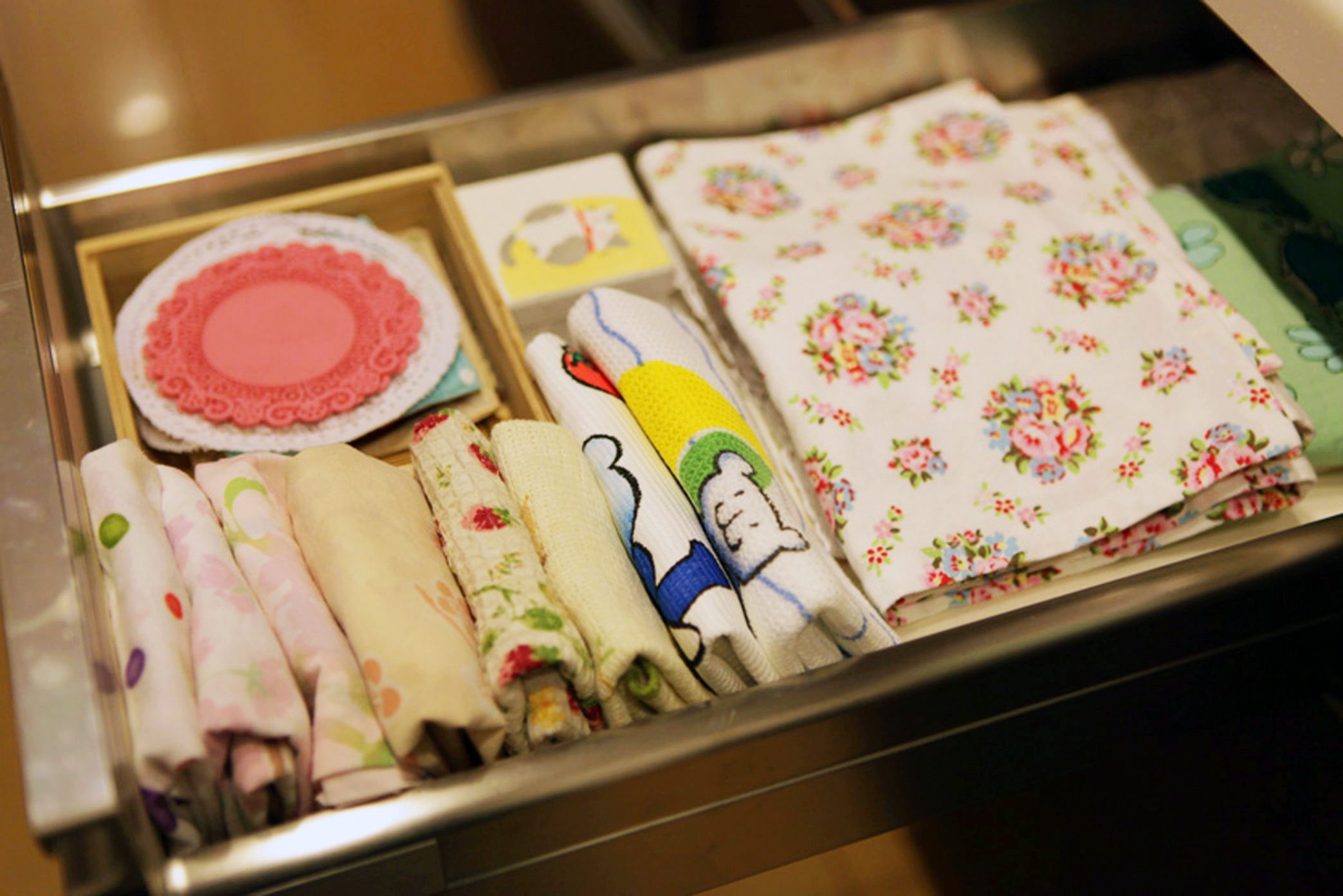 Linen items are neatly folded in a drawer.