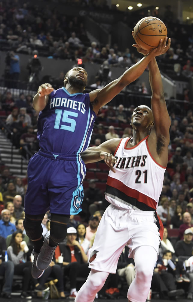 Charlotte Hornets forward Michael Kidd-Gilchrist (14) has his shot blocked by Portland Trail Blazers forward Noah Vonleh (21) during the first half of an NBA basketball game in Portland, Ore., Friday, Jan. 29, 2016.