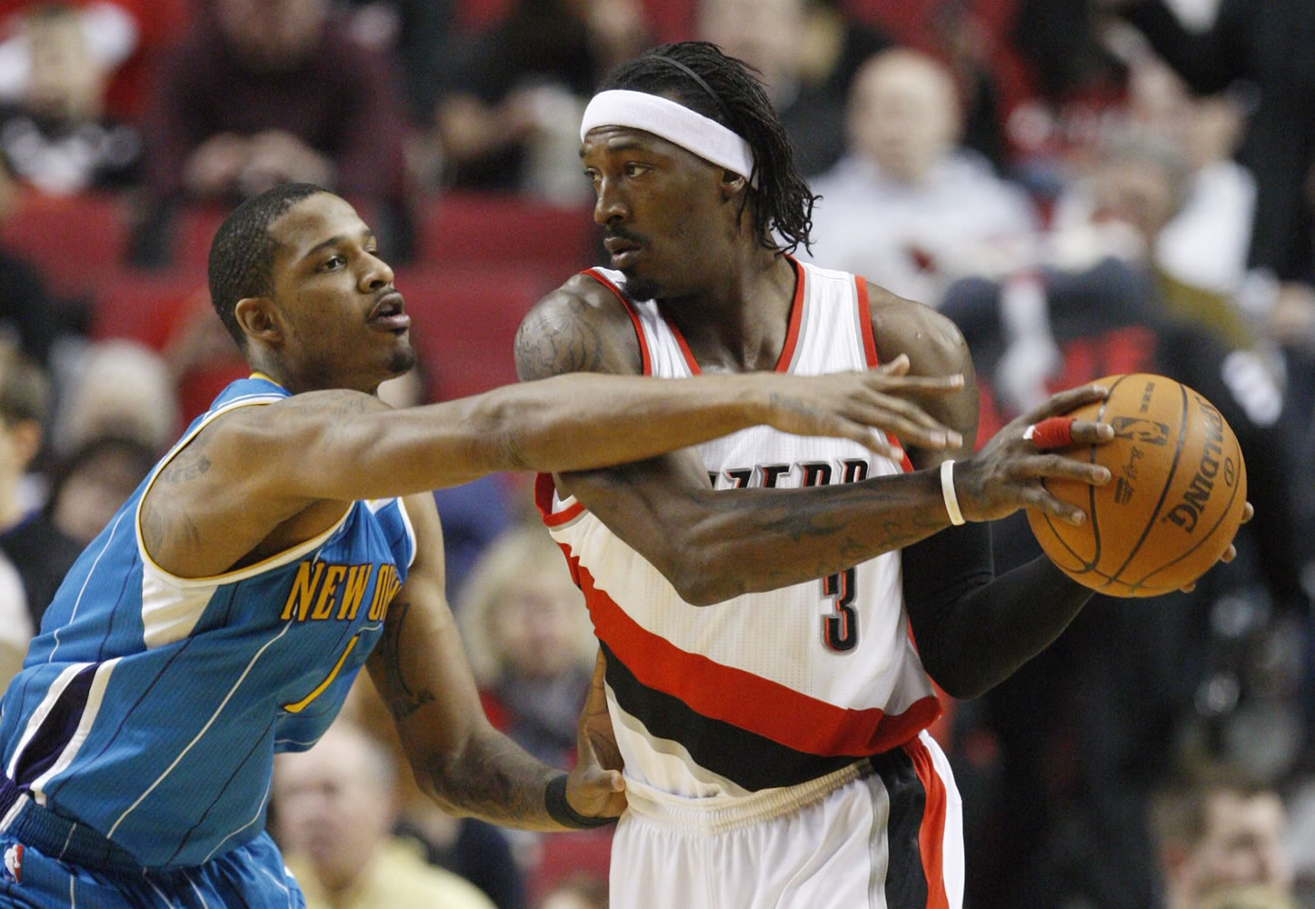 New Orleans Hornets' Trevor Ariza (1) defends against Portland Trail Blazers' Gerald Wallace (3) in the first quarter during an NBA basketball game Monday, March 5, 2012, in Portland, Ore.