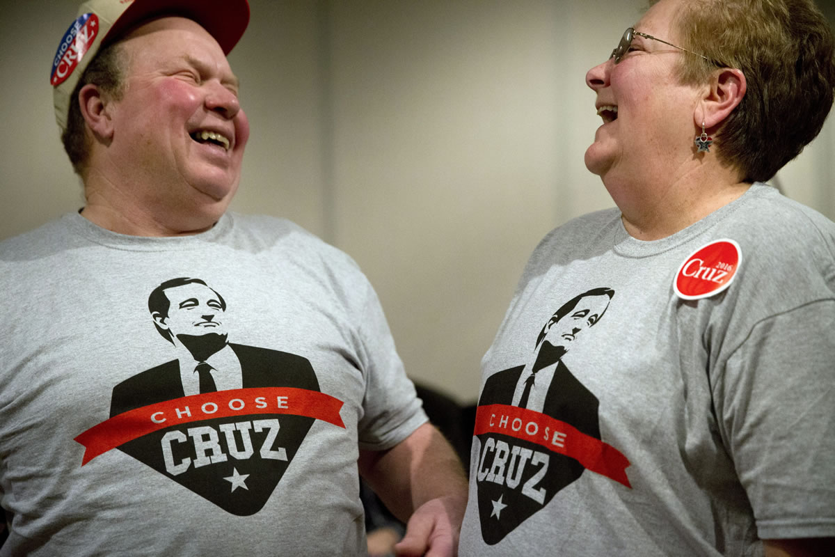 Wearing the same shirt to show their support for Republican presidential candidate, Sen. Ted Cruz, R-Texas, Denny Swaim, left, and wife, Sandi share a laugh at a campaign event at Bridge View Center in Ottumwa, Iowa.  (AP Photo/Jae C.