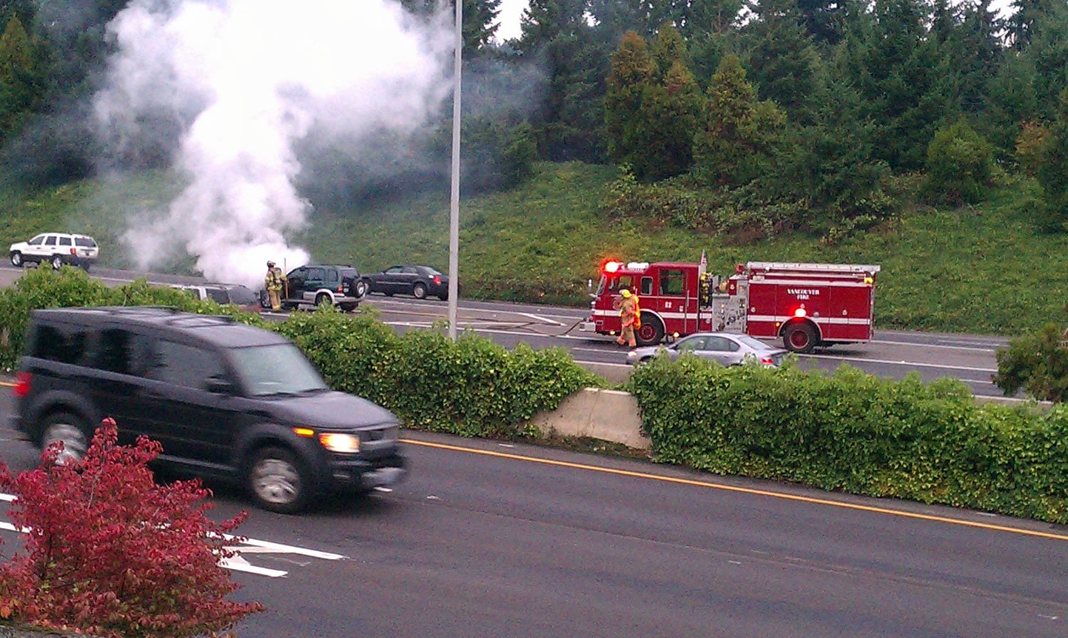 Vancouver firefighters tend to a burning SUV along Interstate 5 Sunday evening.