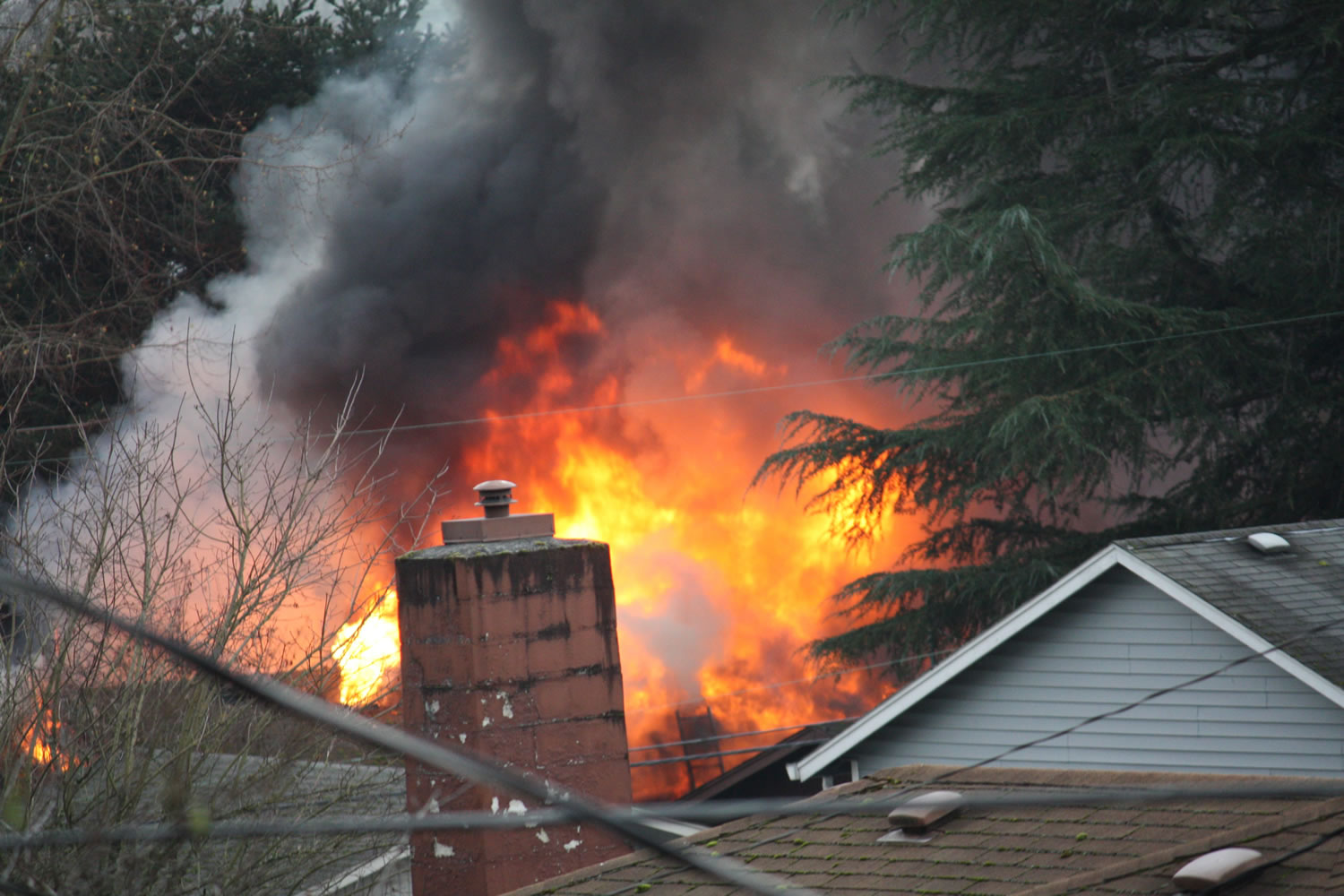 A fire rages at 3275 F Place in Washougal after shots were fired at firefighters on Dec.
