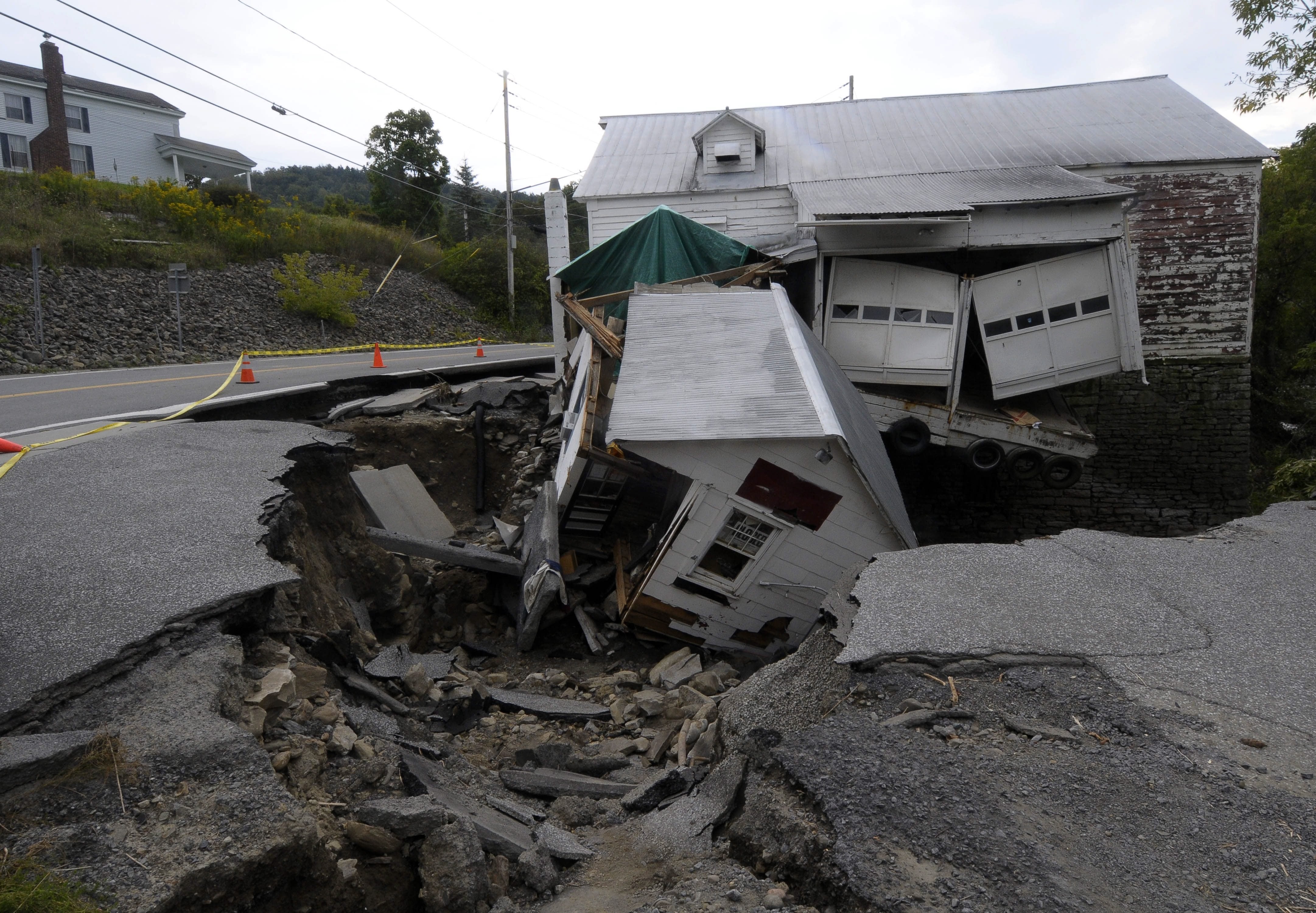 Buildings lie in ruins Thursday on a damaged road as a result of Hurricane Irene in Berne, N.Y.