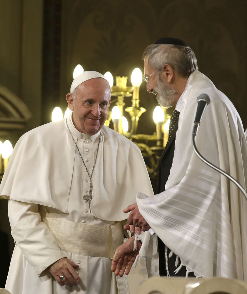 Pope Francis, left, shakes hands with Rabbi Riccardo Di Segni, after he delivered his speech Sunday during his visit to the Great Synagogue of Rome. Pope Francis made his first visit to a synagogue as pope Sunday.