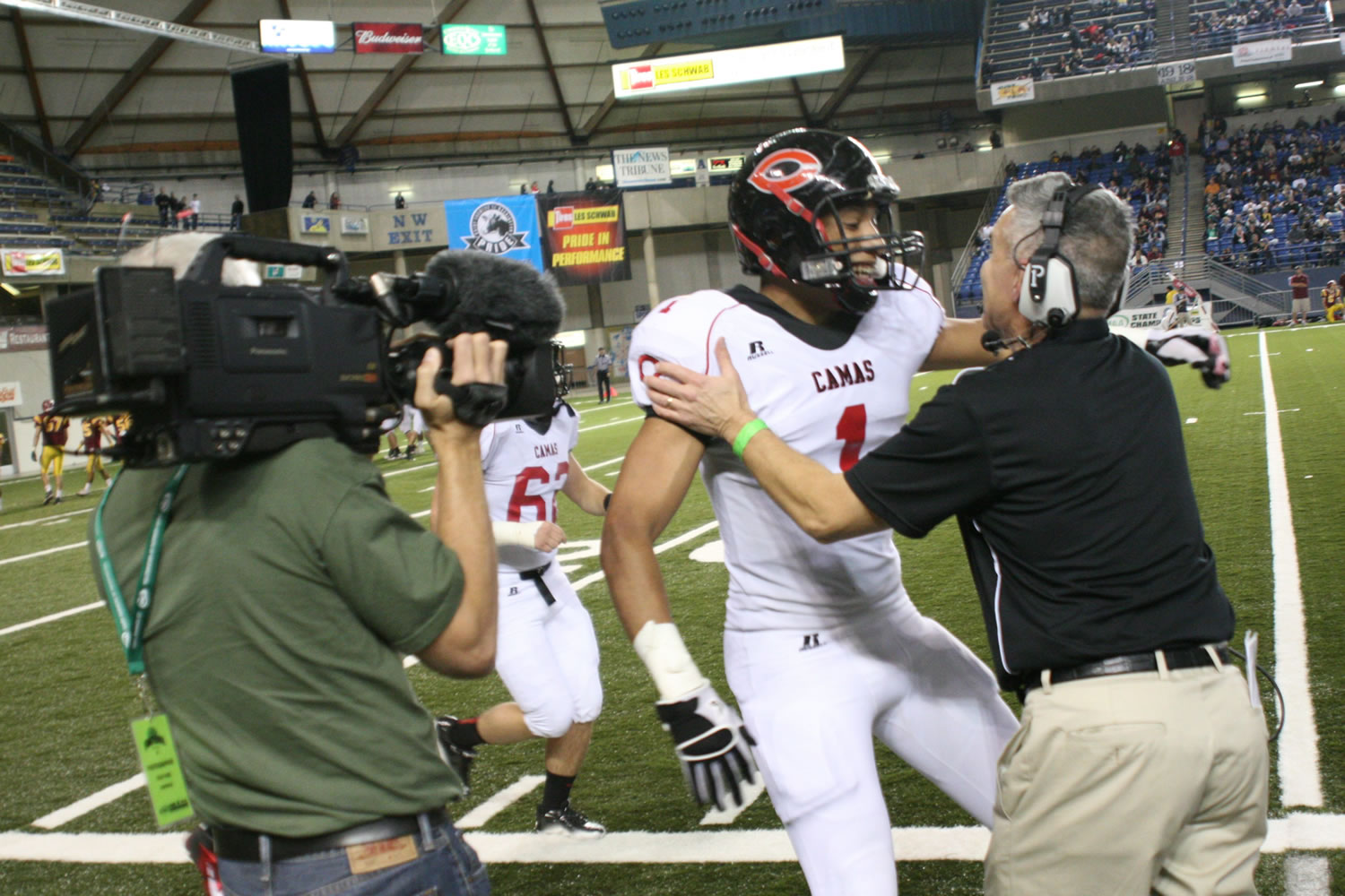 Camas head coach Jon Eagle embraces Jonathan Warner after he scores the first touchdown for th Papermakers at the Tacoma Dome.