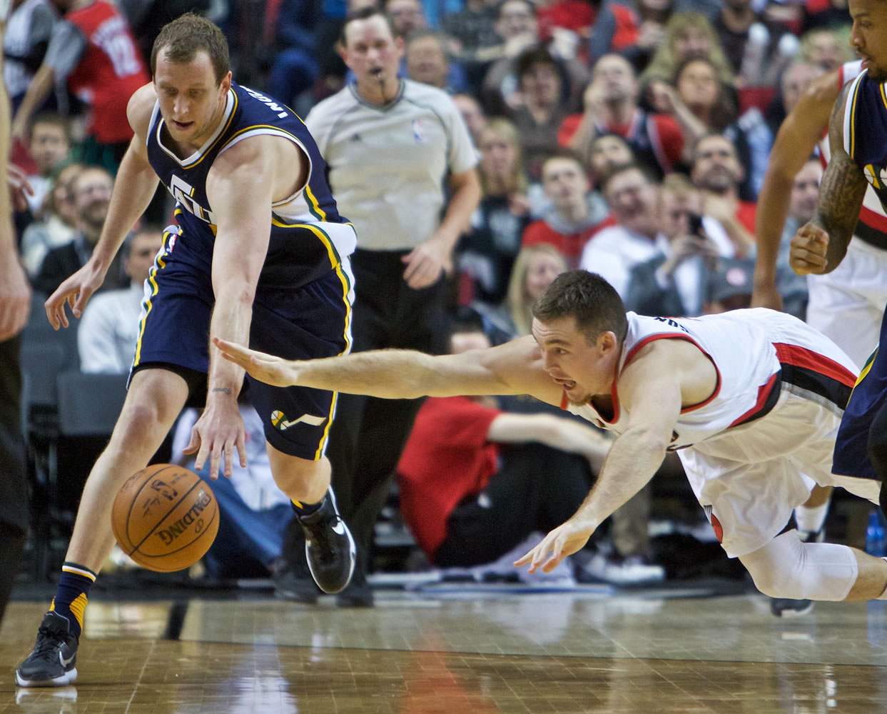 Portland Trail Blazers guard Pat Connaughton, right, dives for the ball in front of Utah Jazz forward Joe Ingles, left, during the second half of an NBA basketball game in Portland, Ore., Wednesday, Jan. 13, 2016. The Trail Blazers won 99-85.