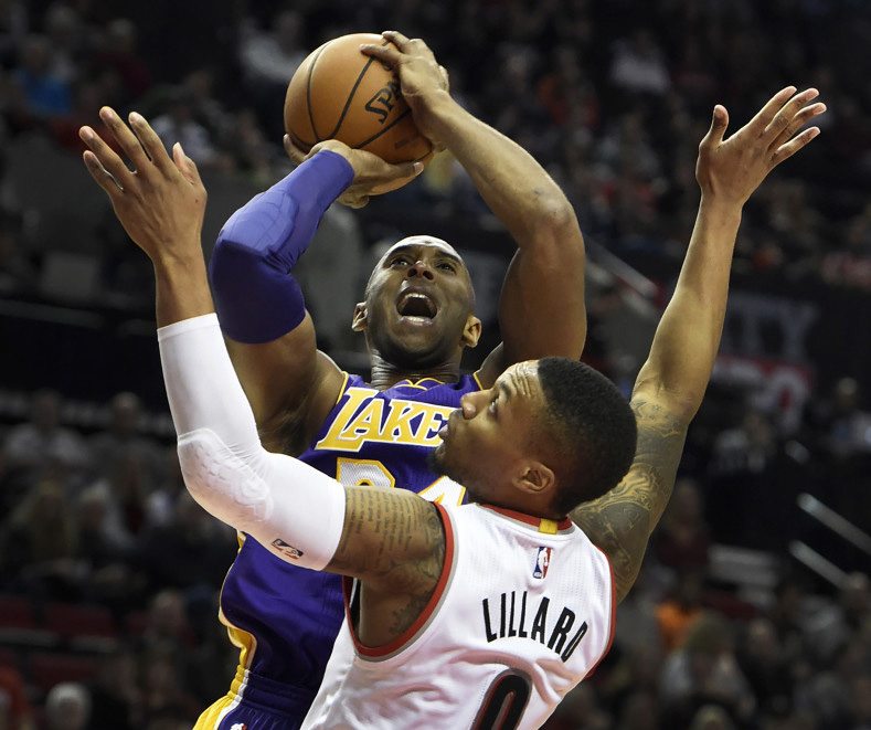 Los Angeles Lakers forward Kobe Bryant (24) shoots the ball over Portland Trail Blazers guard Damian Lillard (0) during the first half of an NBA basketball game on Saturday, Nov. 28, 2015, in Portland, Ore.