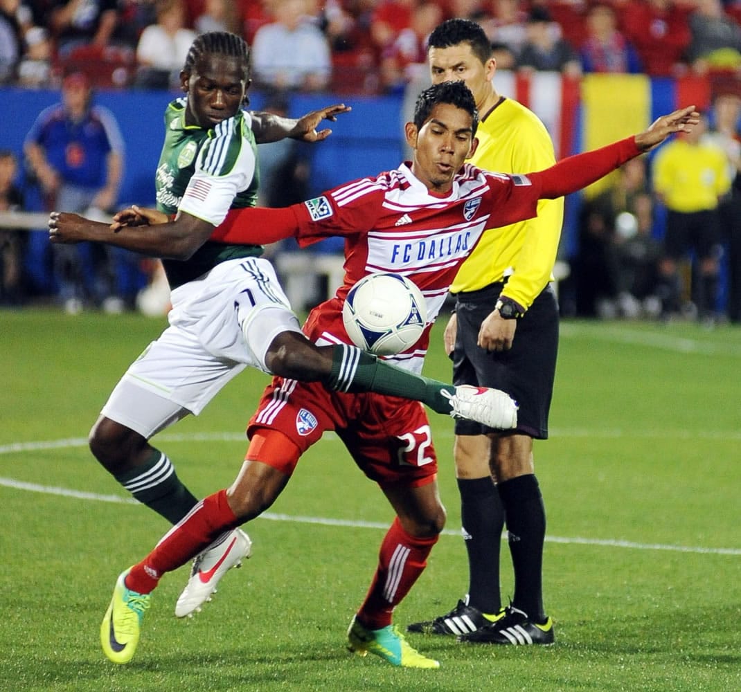 FC Dallas' Carlos Rodriguez, right, fights for the ball with Portland Timbers' Chris Taylor during an MLS.