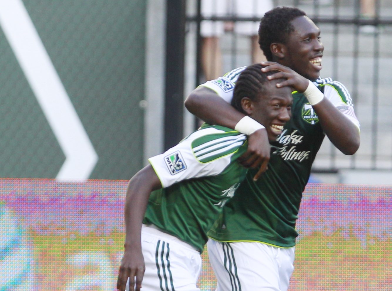 Portland Timbers' midfielder Diego Chara, left, is hugged by teammate Portland Timbers' Kalif Alhassan, right, after scoring during the first half Saturday.