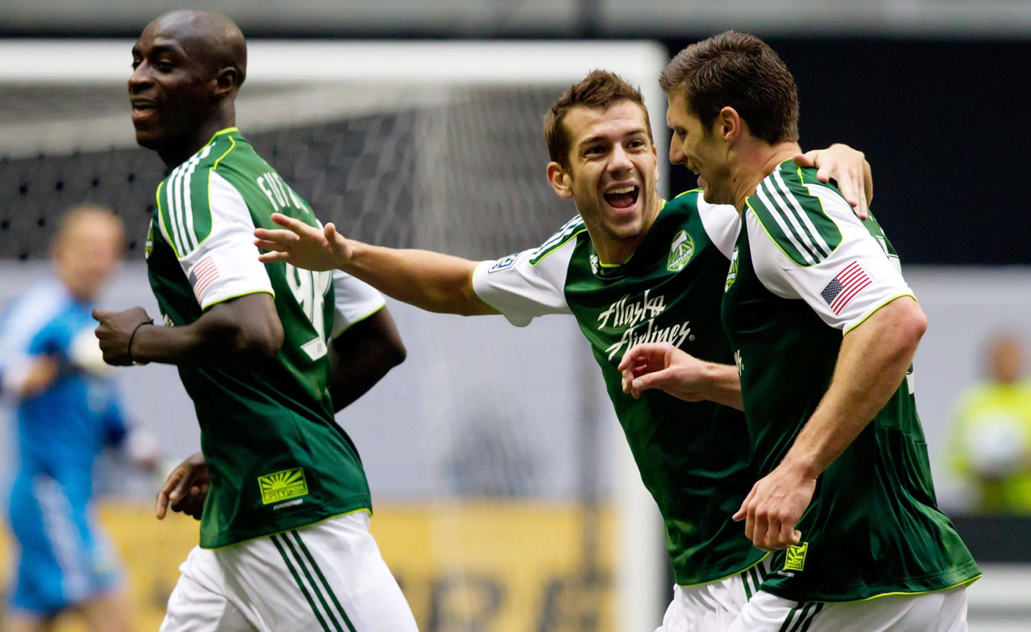Portland Timbers' Mamadou Danso, from left, Eric Brunner and Kenny Cooper celebrate Cooper's goal against the Vancouver Whitecaps during the first half Sunday.