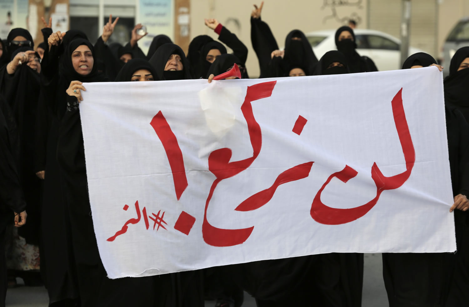 Bahraini protesters carry a banner reading, "We will not bow! #alNimr," during a demonstration against Saudi Arabia's execution of Shiite cleric Sheikh Nimr al-Nimr, in Daih, Bahrain, Saturday, Jan. 2, 2016. Saudi Arabia announced Saturday it had executed 47 prisoners convicted of terrorism charges, including al-Qaida detainees and al-Nimr, who rallied protests against the Saudi government. The execution of al-Nimr is expected to deepen discontent among Saudi Arabia's Shiite minority and heighten sectarian tensions across the region.