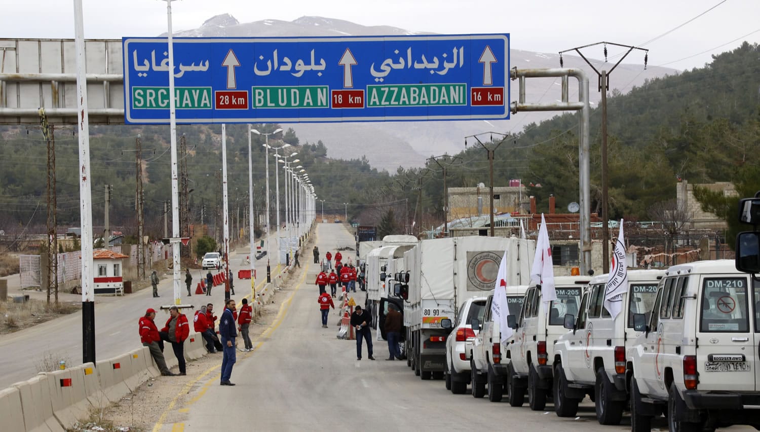 A convoy of vehicles loaded with food and other supplies organized by the International Committee of the Red Cross, working with the Syrian Arab Red Crescent and the United Nations, makes its way Monday to the besieged town of Madaya, about 15 miles northwest of Damascus, Syria.